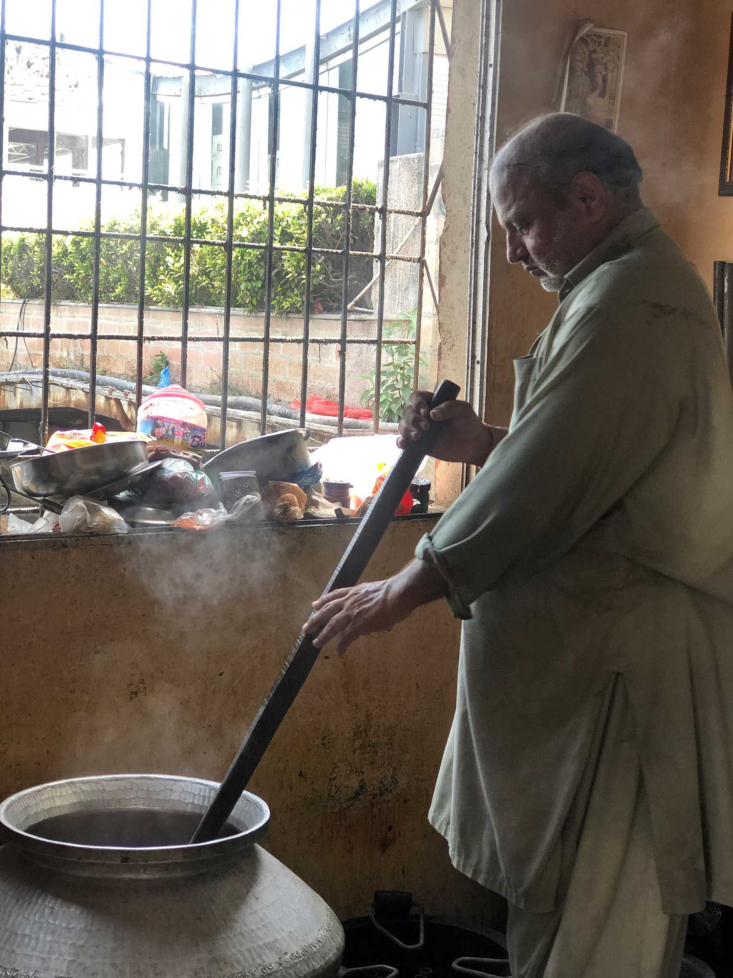 Maharaj starts to cook the vegetable biryani.