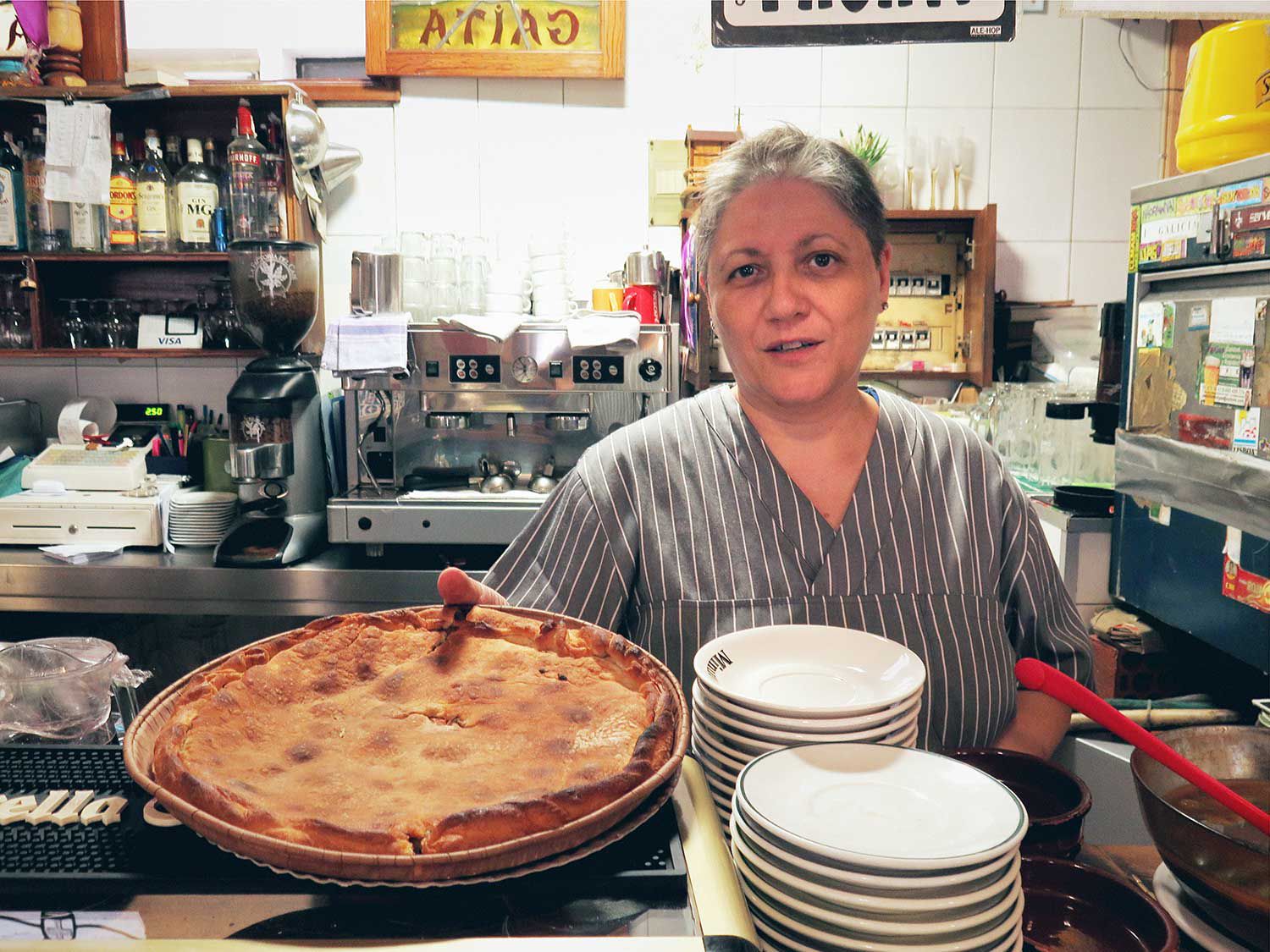 While the neighborhood has evolved around Bar a Miña Gaita, Rocha still makes her traditional Galician <em>Empanada de Atún</em> (tuna pie) every day.
