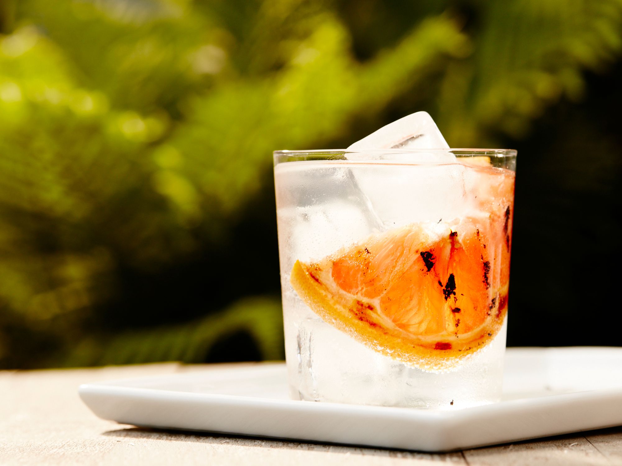 Meant for long afternoons overlooking lakes, porches, and thick novels, gin and tonics are the balm of summer. Add a slice of salt-sprinkled grilled grapefruit, and cut the tonic with soda, and the highball grows not only more aromatically complex, but even more refreshing. <a href="http://www.saveur.com/smoky-grapefruit-gin-and-tonic-recipe">Get the recipe for Smoky Grapefruit Gin and Tonic</a>