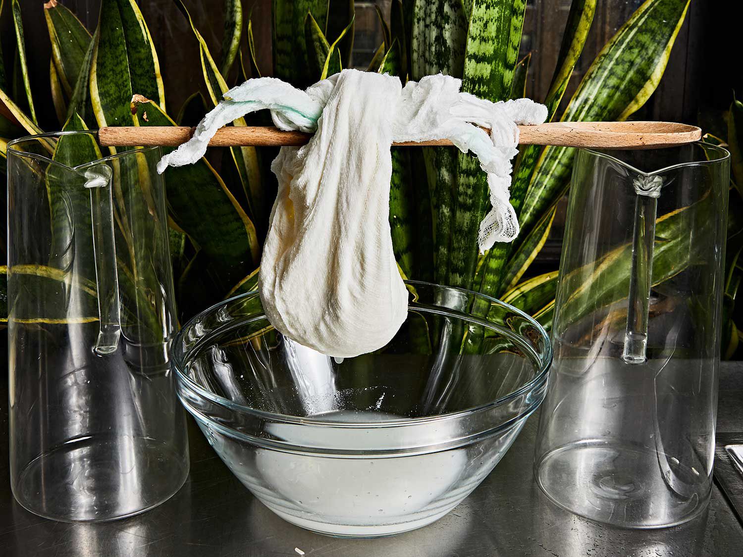 Let your sack of curds hang from a wooden spoon over a bowl or pot.