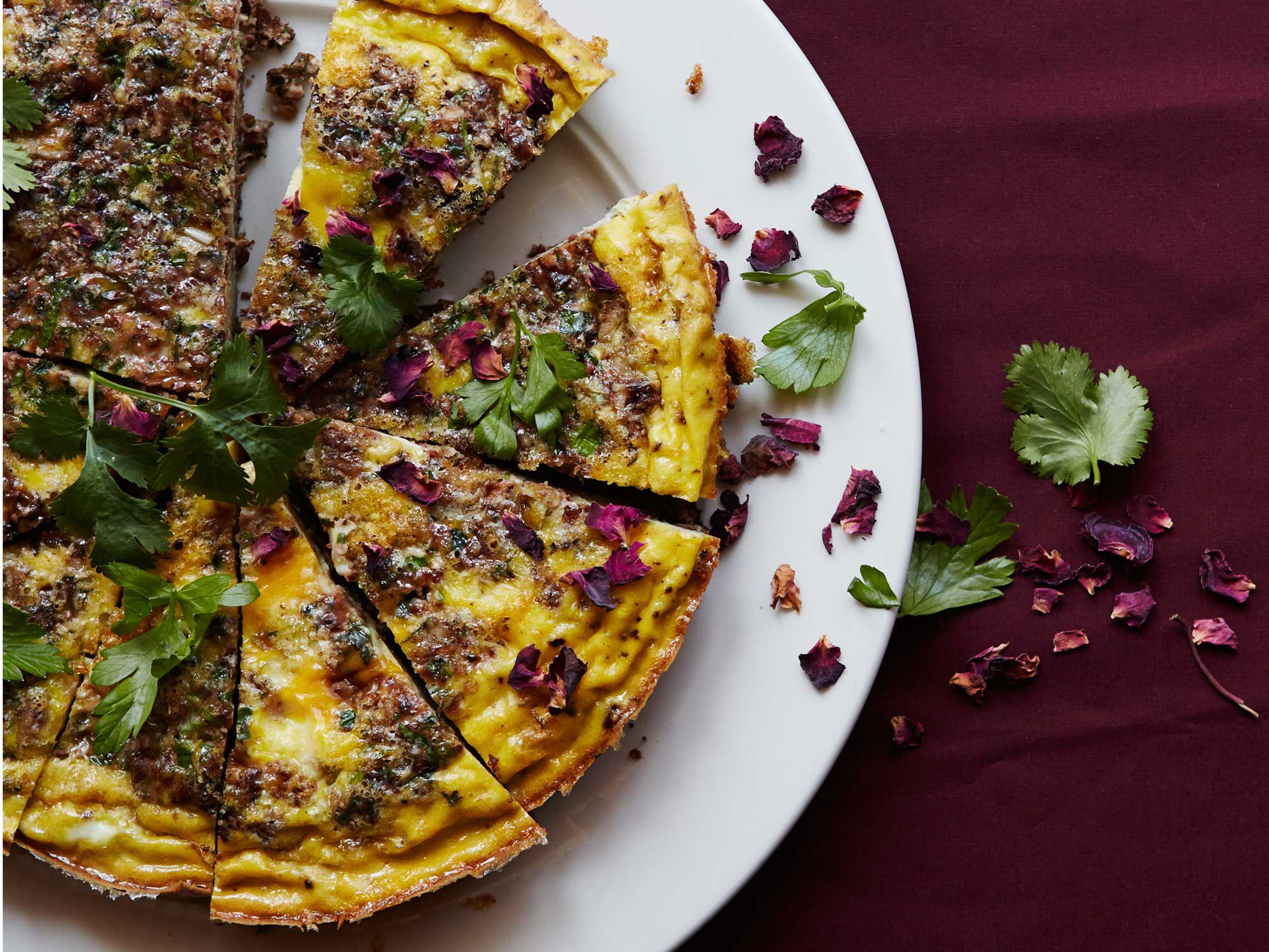 A classic Persian herb-loaded egg dish with the fragrant lift of rose petals. <a href="https://www.saveur.com/persian-kuku-sabzi-eggs-rose-recipe">Get the recipe for Persian Kuku Sabzi</a>