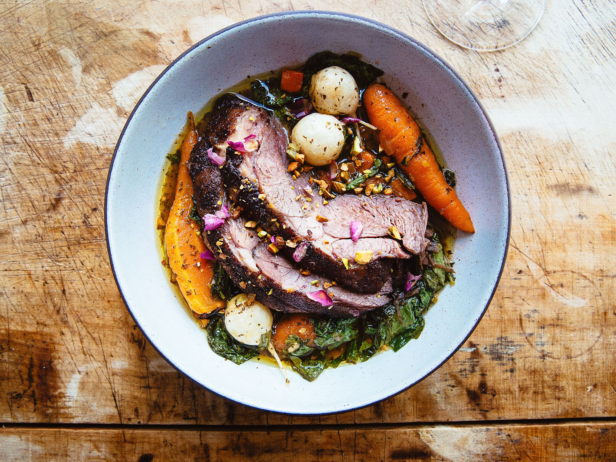This recipe comes from Sam Smith, Of Tusk in Portland, Oregon. Smith notes: "I like to eat it with a steak knife, keep some texture." Serve this with lots of bread for soaking up the juices; a simple mixed green salad with champagne vinegar, black pepper, and edible flowers if available; and a super cold rose or white wine. <a href="https://www.saveur.com/braised-lamb-shoulder-with-rose-turnips-and-pistachios-recipe">Get the recipe for Braised Lamb Shoulder with Rose, Turnips, and Pistachios</a>