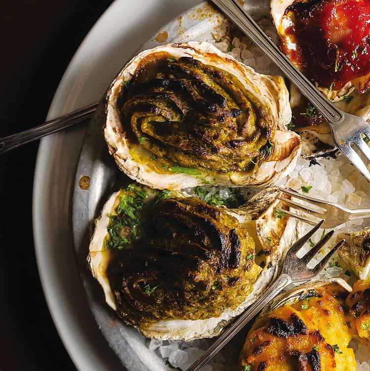 This ubiquitous New Orleans dish was invented at Antoine's in 1889. <a href="https://www.saveur.com/article/Recipes/Oysters-Rockefeller-recipe">Get the recipe for Oysters Rockefeller</a>
