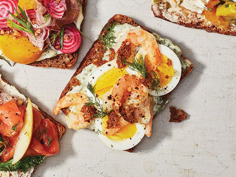 The bread is always primed with a thin layer of butter, goose fat, or another rich spread, which prevents the bread from getting soggy beneath juicier toppings. “In the old days, smørre­brød were basically a tsunami of meat,” says Danish Chef Adam Aamann. Roasted or fried beef was classic, as was liver pâté. But even on seafood or vegetable smørrebrød—especially when the vege­tables are bitter—you always want some form of fat or richness: mayonnaise, butter, chopped avocado, or cheese (just not with fish). Get the recipe for <a href="https://www.saveur.com/smorrebrod-eggs-shrimp-dill-recipe/">Smørrebrød of Eggs, Shrimp, and Dill</a>