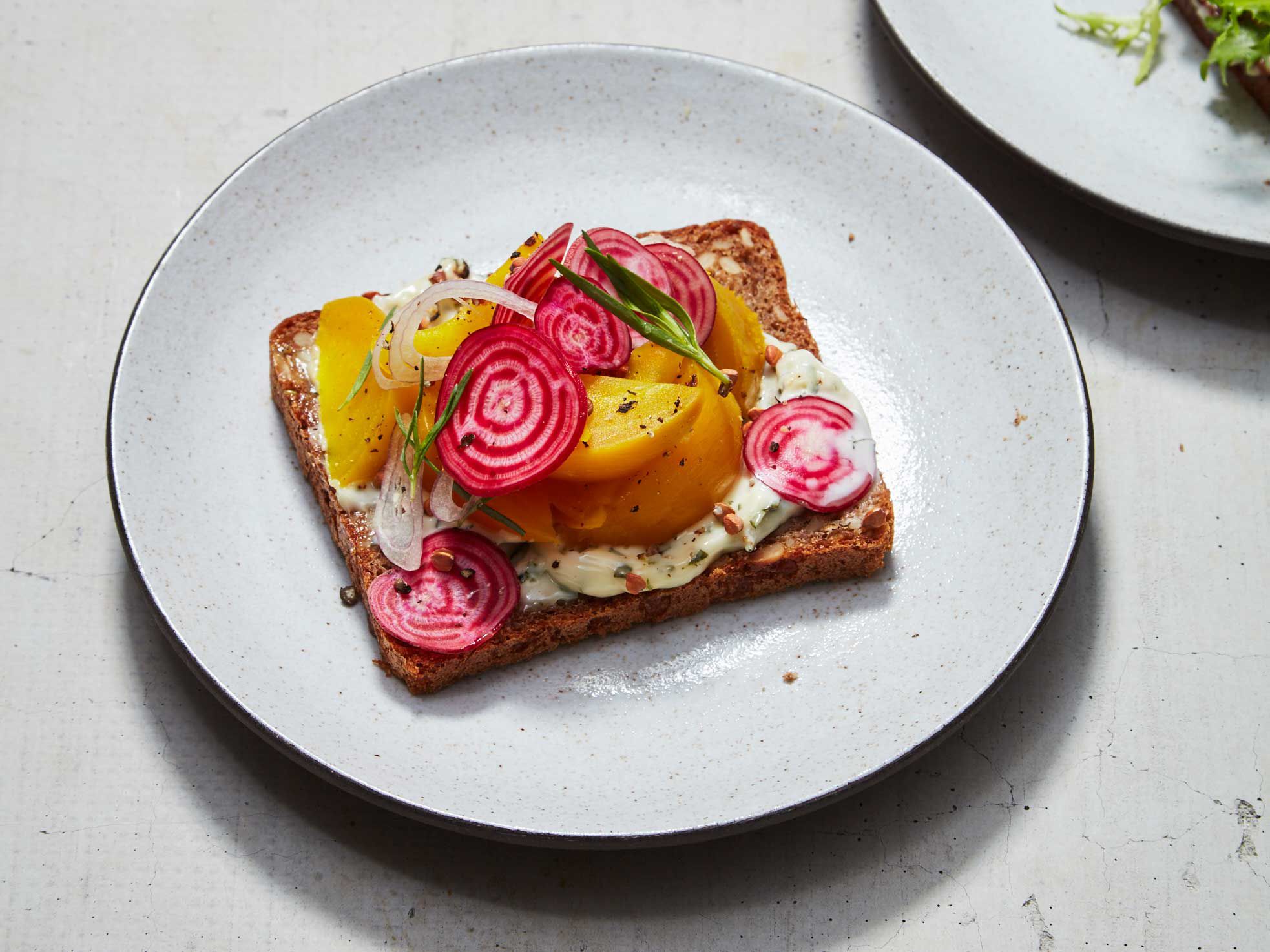 Smørrebrød are <em>never eaten</em> out of hand: serve and eat them with a knife and fork and always in the proper order. When sampling a variety of different toppings, pickled or smoked herring is always eaten first, followed by other seafood. Meat are to be eaten third, followed by cheese. Two to three pieces are the typical serving size; if you prefer to sample a wider variety, cut your bread slices in half <em>before</em> composing petite versions. Get the recipe for <a href="https://www.saveur.com/beet-smorrebrod-recipe/">Beet Smørrebrød</a>
