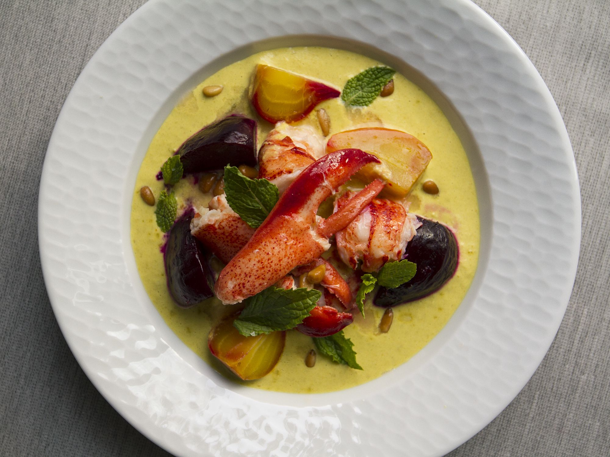 Sweet, tender pieces of lobster and beets are topped with a rich asparagus cream sauce in this recipe from Oyster Club in Mystic, Connecticut. Get the recipe for <a href="https://www.saveur.com/lobster-asparagus-cream-beets-recipe/">Butter-Poached Lobster with Asparagus-Saffron Cream and Roasted Beets</a>