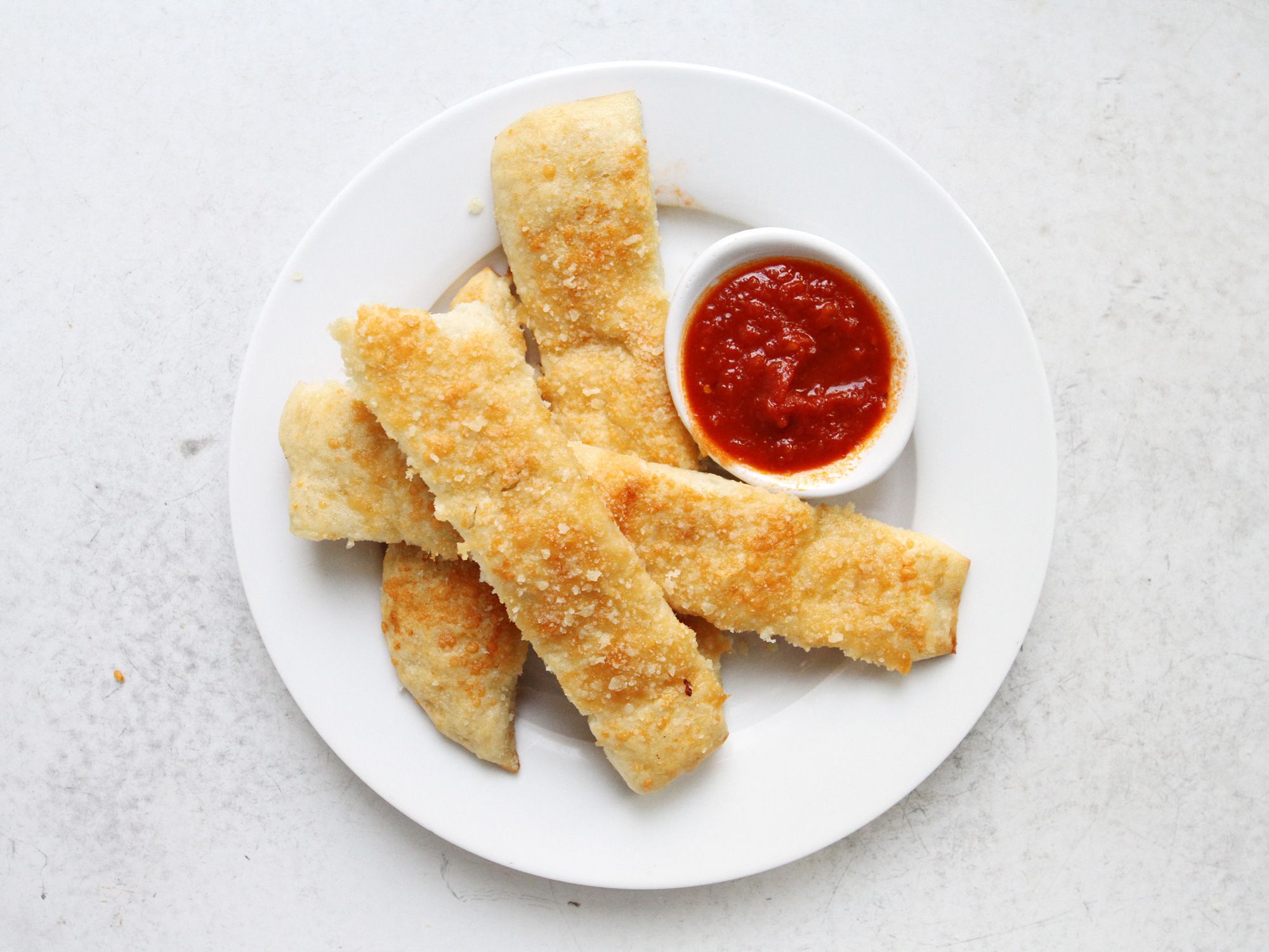 Add a little kick to this homemade version of Little Caesar's "Crazy Bread" by sprinkling on a little chile flake before dunking in hot marinara. Get the recipe for <a href="https://www.saveur.com/crazy-bread-recipe/">Crazy Bread</a>