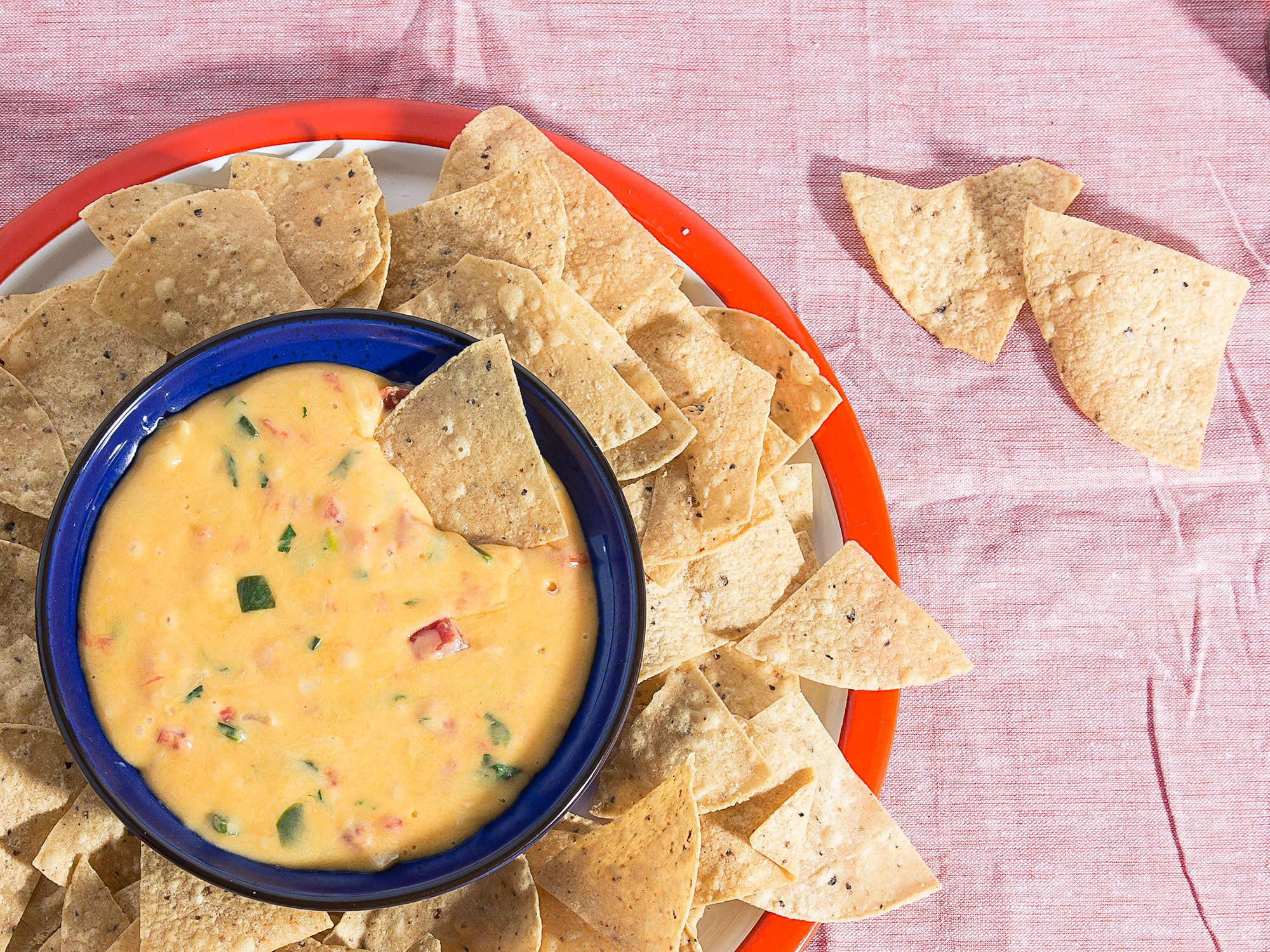 This classic Tex-Mex dip comes from Lisa Fain (a.k.a. The Homesick Texan). With both serrano chiles and jalapeños, the dip has a bright spiciness that cuts through the richness of two cheeses. The tangy sour cream added at the end brings it over the top. Get the recipe for <a href="https://www.saveur.com/queso-dip-recipe">Chile con Queso</a>