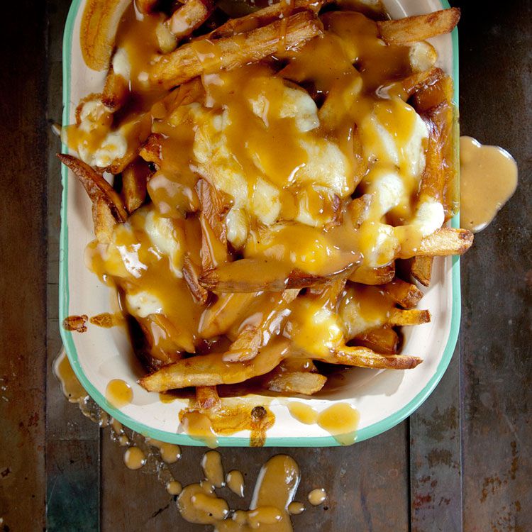 An unabashedly savory collage of french-fried potatoes, beef gravy, and squeaky-fresh cheese curds, poutine is perhaps the ultimate late-night snack. Get the recipe for <a href="https://www.saveur.com/poutine-classic-gravy-fries-recipe/">Poutine (French Fries with Gravy and Cheese Curds)</a>