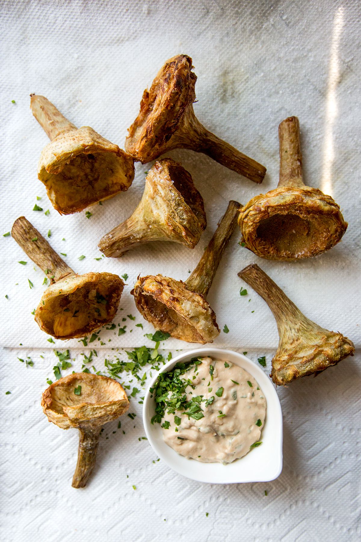 We found this recipe—a flavorful local favorite, in which tender artichoke bottoms are fried and served with an intense, tahini-based sauce—at al-Az, a casual but well-known restaurant in Damascus. Get the recipe for <a href="https://www.saveur.com/article/Recipes/Fried-Artichoke-Hearts-with-Taratur-Sauce/">Fried Artichoke Hearts with Taratur Sauce</a>