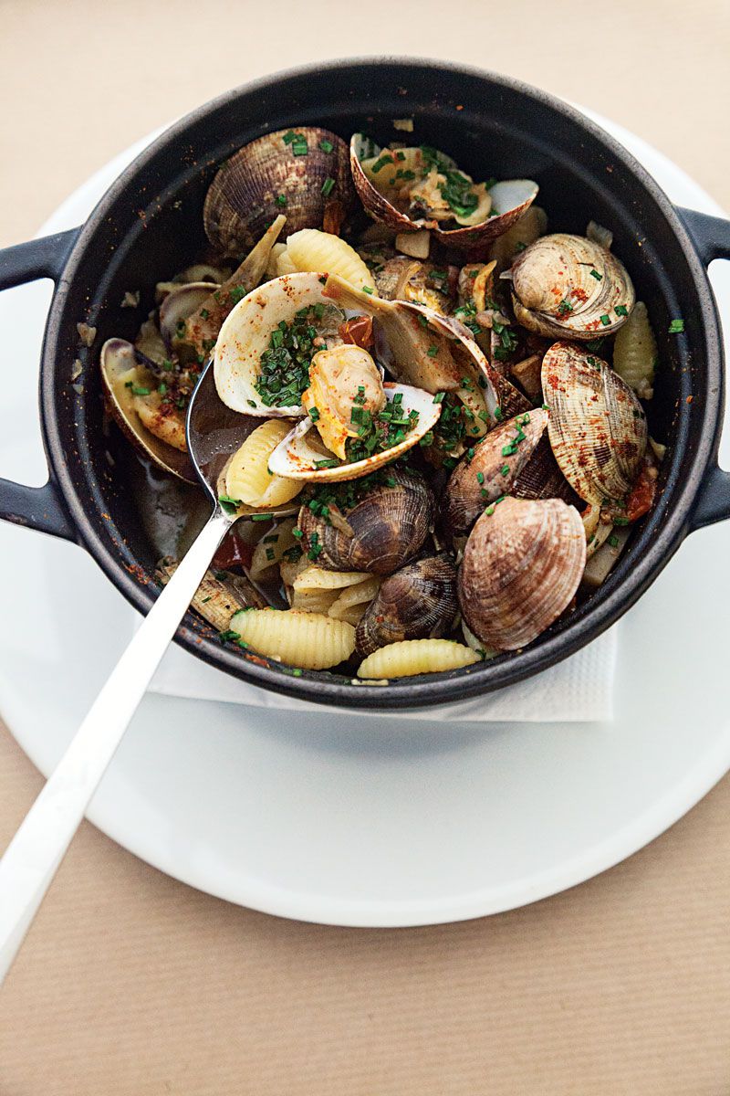 In this aromatic dish, shell-shape pasta is dressed in a light tomato and clam sauce with artichoke hearts. Get the recipe for <a href="https://www.saveur.com/article/recipes/pasta-shells-with-artichoke-clam-sauce/">Pasta Shells with Artichoke-Clam Sauce</a>