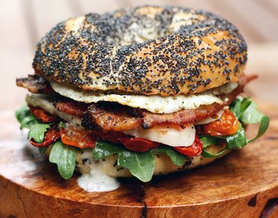 A toasted poppy seed bagel is piled high with crisp greens, oven-dried tomatoes, roasted chicken, bacon, a fried egg, and homemade buttermilk dressing for a decadent spin on the traditional club sandwich. Get the recipe for <a href="https://www.saveur.com/article/Recipes/Chicken-and-Egg-Club-Sandwich/">Chicken and Egg Club Sandwich</a>