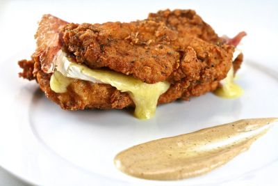 Essentially a gussied-up version of chicken Cordon Bleu, we give KFC's bun-less Double Down chicken sandwich a refined makeover. Get the recipe for <a href="https://www.saveur.com/article/Recipes/Homemade-Double-Down/">Homemade Double Down</a>