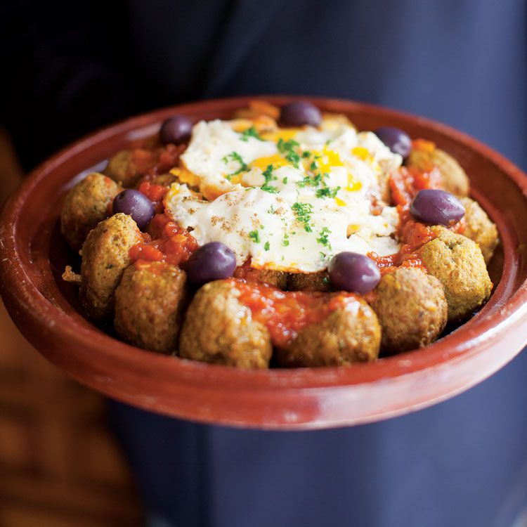 Cumin- and paprika-spiced <em>kefta</em> (lamb meatballs), baked eggs, and kalamata olives are the hallmarks of this elegant tagine from the Moroccan restaurant Le Timgad in Paris. Get the recipe for <a href="https://www.saveur.com/article/Recipes/Lamb-Meatball-Egg-Tagine">Kefta Tagine (Lamb Meatball and Egg Tagine)</a>