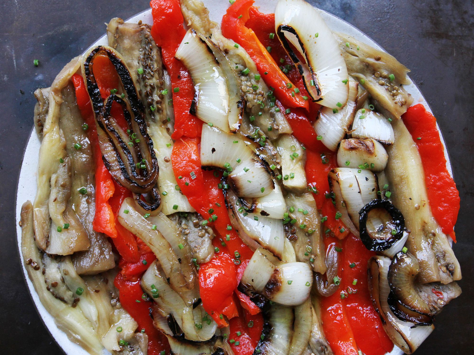 Akin to Puerto Rican <em>escabeche</em>, roasted, tender vegetables are marinated in a simple sherry vinegar dressing for an easy side dish to grilled fish, roast pork, or tender rib eye steak. Get the recipe for <a href="https://www.saveur.com/escalivada-catalana-recipe/">Escalivada Catalana</a>