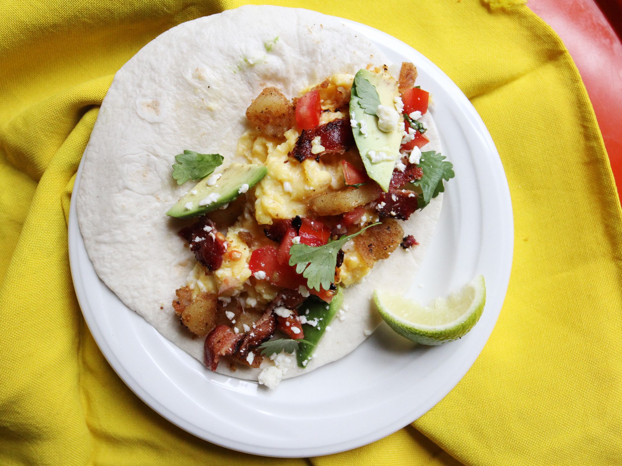 The fully loaded breakfast taco has avocado, salty cheese, creamy eggs, and crisp bacon. Get the recipe for <a href="https://www.saveur.com/breakfast-taco-recipe/">Fully Loaded Breakfast Tacos</a>