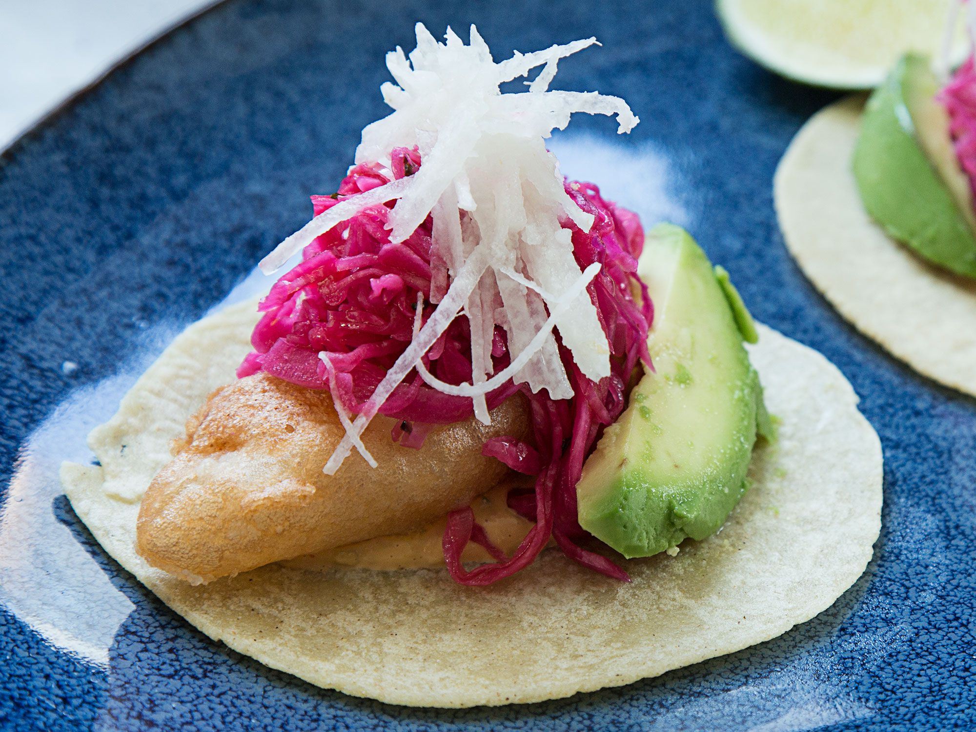 Chef Jose Garces uses a batter of rice flour and vodka to produce shatteringly crisp fish bites that he then stuffs into warm tortillas and tops with cool, crunchy slaw. Get the recipe for <a href="https://www.saveur.com/fried-fish-tacos-recipe/">Jose Garces' Fish Tacos</a>