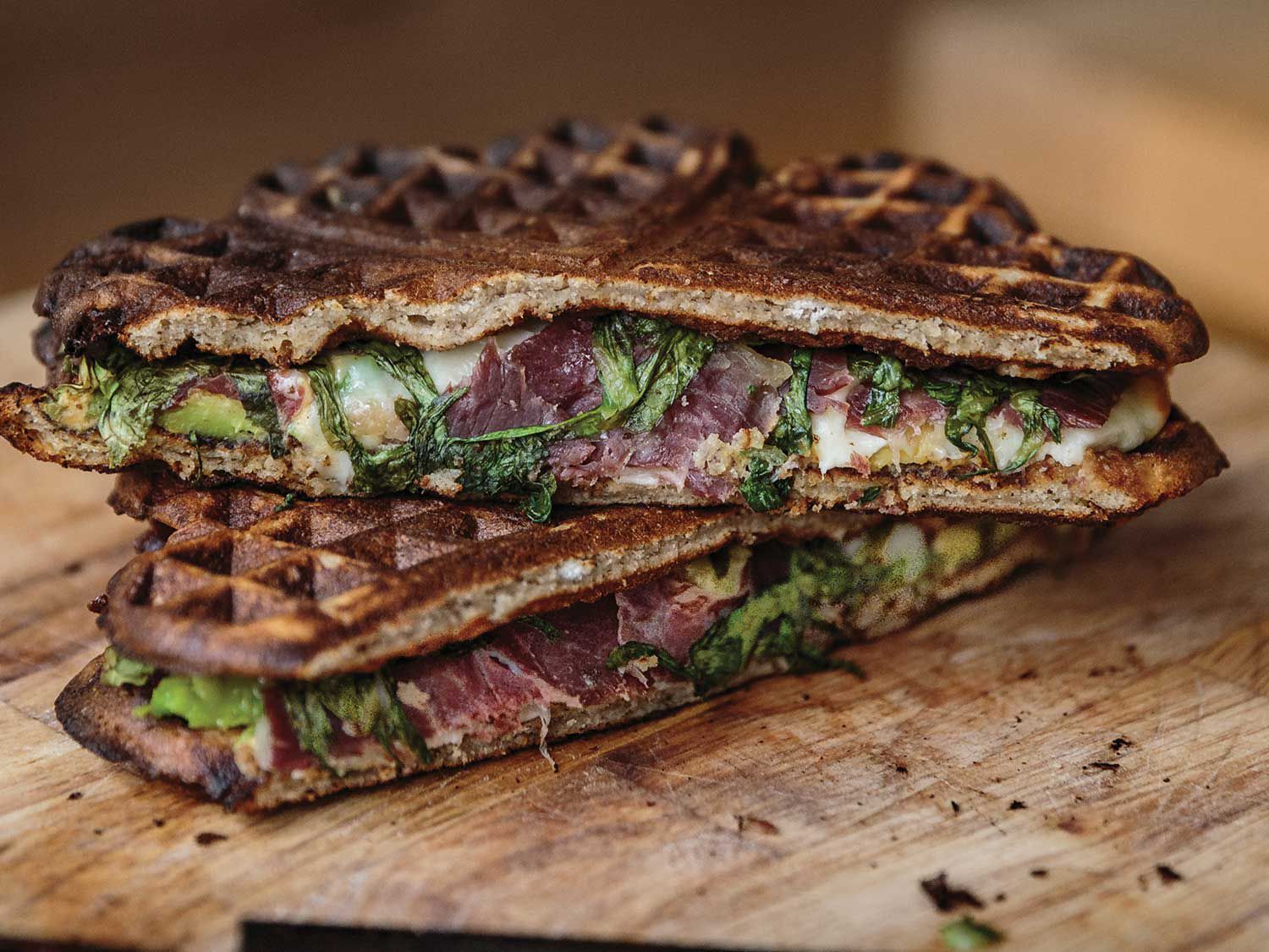 Gooey cheese, salty cured meat, and avocado are pressed between crispy waffles at a modern café in Paris. Get the recipe for <a href="https://www.saveur.com/waffle-sandwiches-recipe/">Waffle Sandwiches with Cecina, Avocado, and Arugula</a>