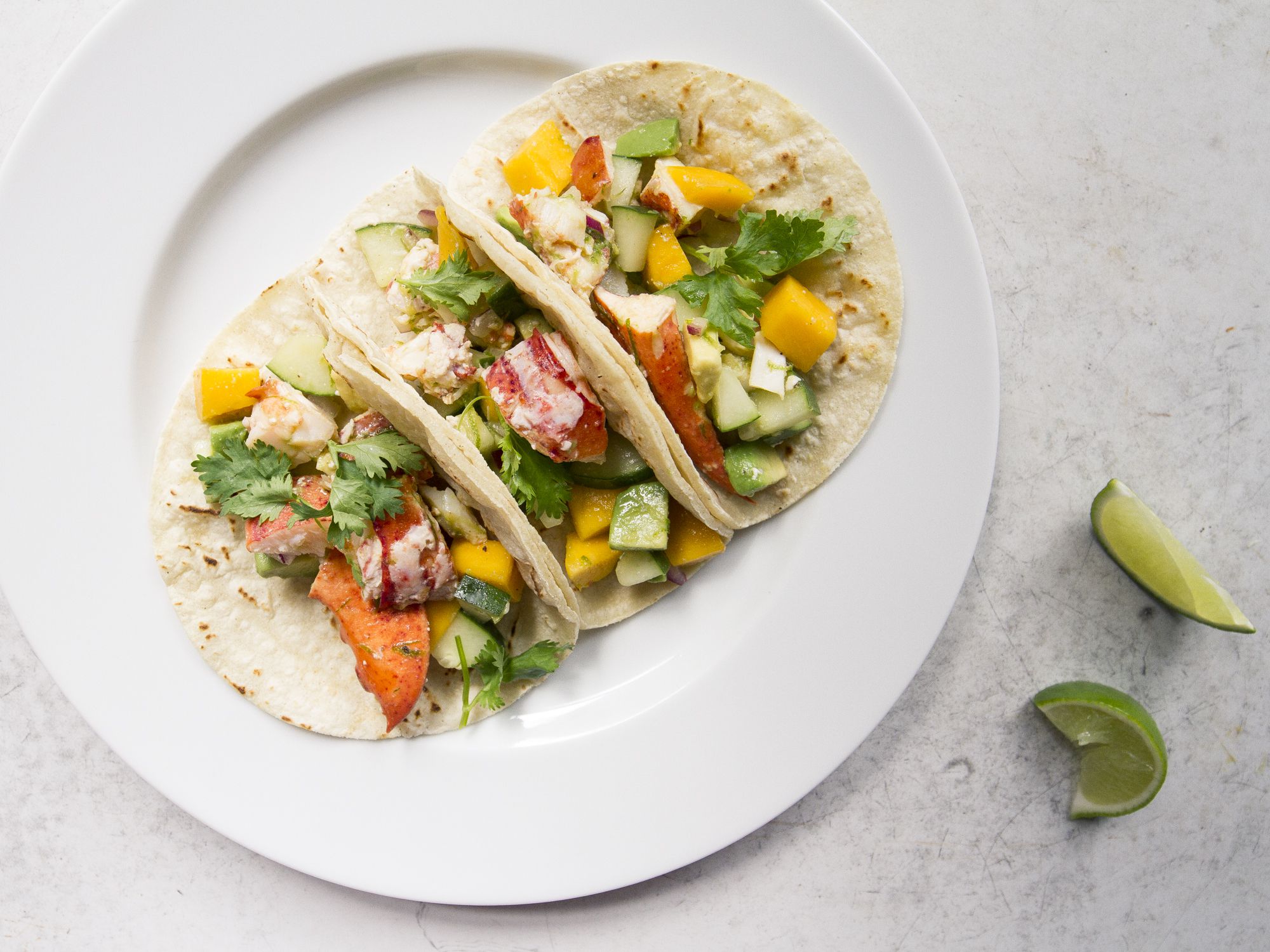 This ode to summer mixes fresh lobster with sweet mango, refreshing cucumber, and creamy avocado. Get the recipe for <a href="https://www.saveur.com/lobster-tacos-recipes/">Summer Lobster Tacos</a>