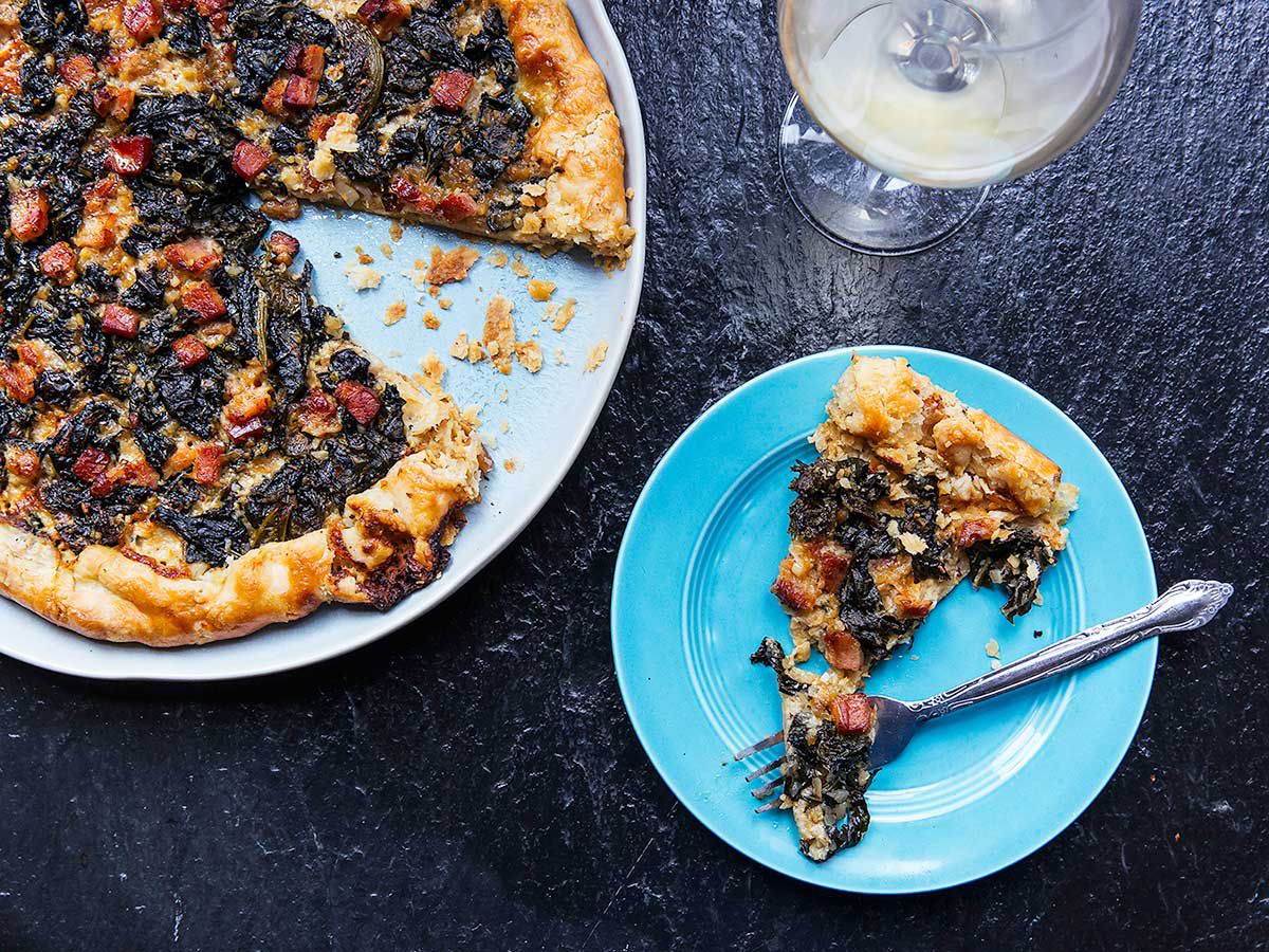 This rustic, free-form tart is filled with a savory layer of crème fraiche and Gruyère, then topped with hearty winter greens, and crispy pancetta. It is a an easy alternative to quiche for lunch or a festive winter breakfast. If you're pressed for time, the flaky butter pie crust can be swapped out for a prepackaged pie dough. Get the recipe for <a href="https://www.saveur.com/galette-with-greens-gruyere-pancetta-recipe">Galette with Greens, Gruyere, and Pancetta</a>