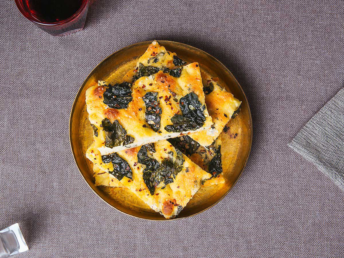 In addition to being baked on an olive oil-slathered pan, this focaccia dough is mixed with olive oil as well as creamy mashed potatoes, giving it a fluffy interior and crispy, oil-slicked edges. Kale and red pepper flakes add color and texture that make an otherwise simple bread a side dish in its own right. Get the recipe for <a href="https://www.saveur.com/tuscan-kale-red-pepper-focaccia-recipe">Tuscan Kale and Red Pepper Focaccia</a>