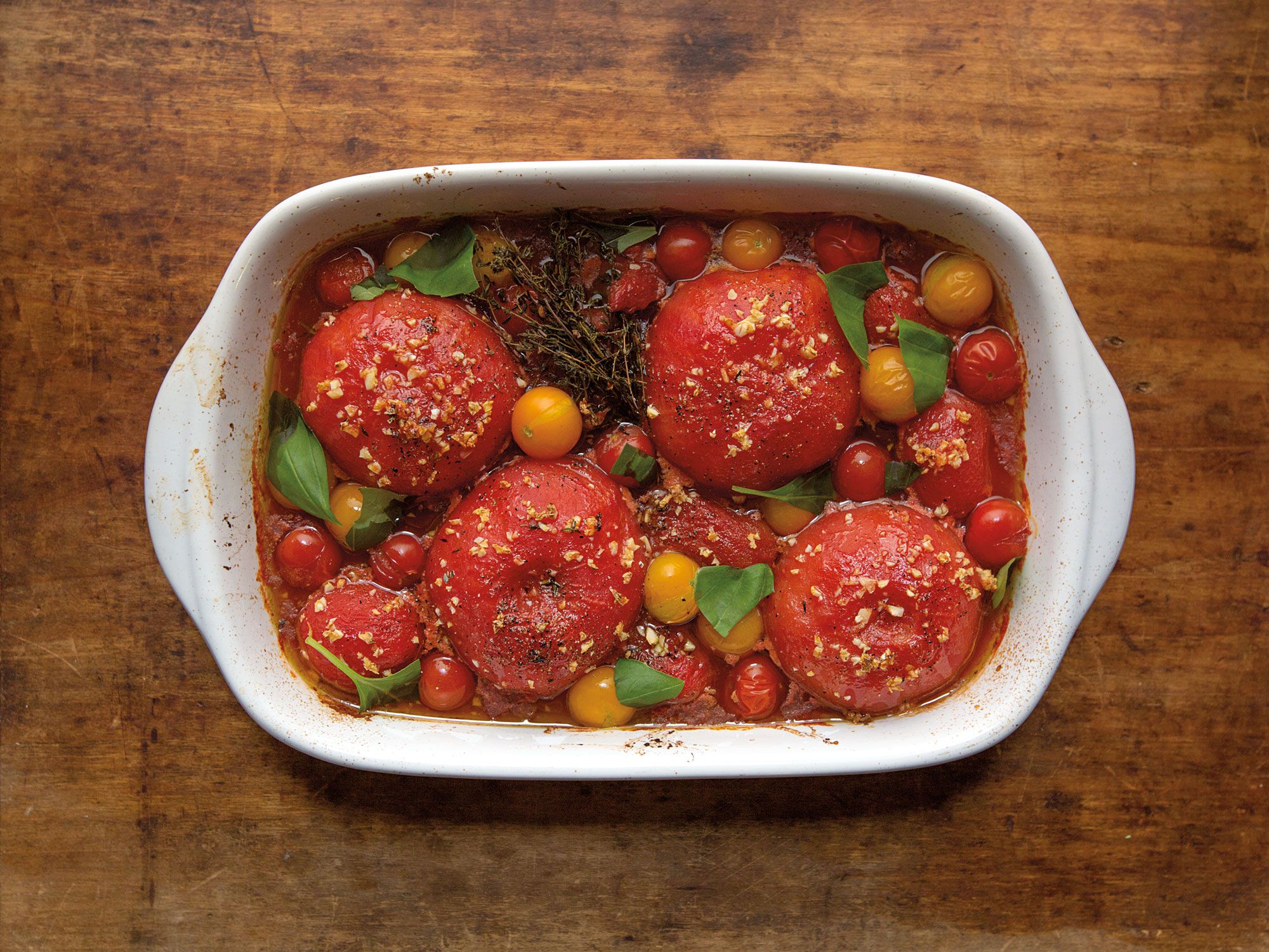 Three types of tomatoes result in a bouquet of flavors and textures, from sweet to burst-in-your-mouth cherries fragrant with Italian herbs. Get the recipe for <a href="https://www.saveur.com/article/Recipes/Oven-Stewed-Tomatoes/">Oven-Stewed Tomatoes</a>