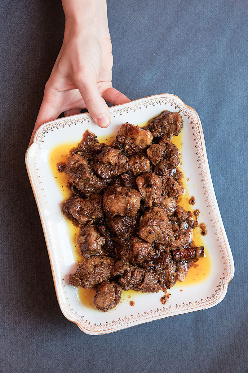 The word vindaloo is a garbled pronunciation of the popular Portuguese dish carne de vinha d'alhos (meat marinated in wine-vinegar and garlic), which made its way to India in the 15th century along with Portuguese explorers. In Goa the dish was tweaked, incorporating chiles, tamarind, black pepper, cinnamon, and cardamom. When it was exported to England, it became another hot curry, losing its vinegar tang and spice complexity, but this version stays close to the Goan original. Get the recipe for <a href="https://www.saveur.com/article/recipes/pork-vindaloo-spicy-goanese-pork-stew/">Goan Pork Vindaloo Curry</a>