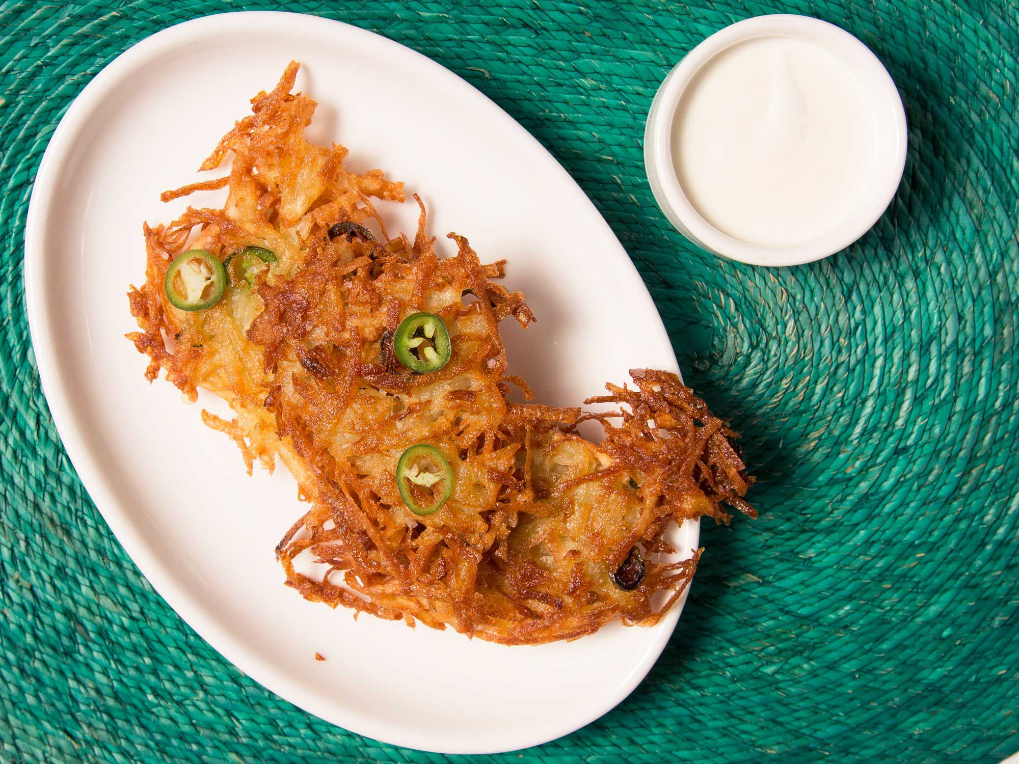 These are classic latkes, grated potatoes bound with matzo meal and egg, but the simple addition of jalapeño adds a new kick to an old Jewish classic. Medina serves his jalapeno latkes with a tangy, cooling horseradish cream. Get the recipe for <a href="https://www.saveur.com/potato-jalapeno-latke-recipe/">Potato Jalapeño Latkes</a>