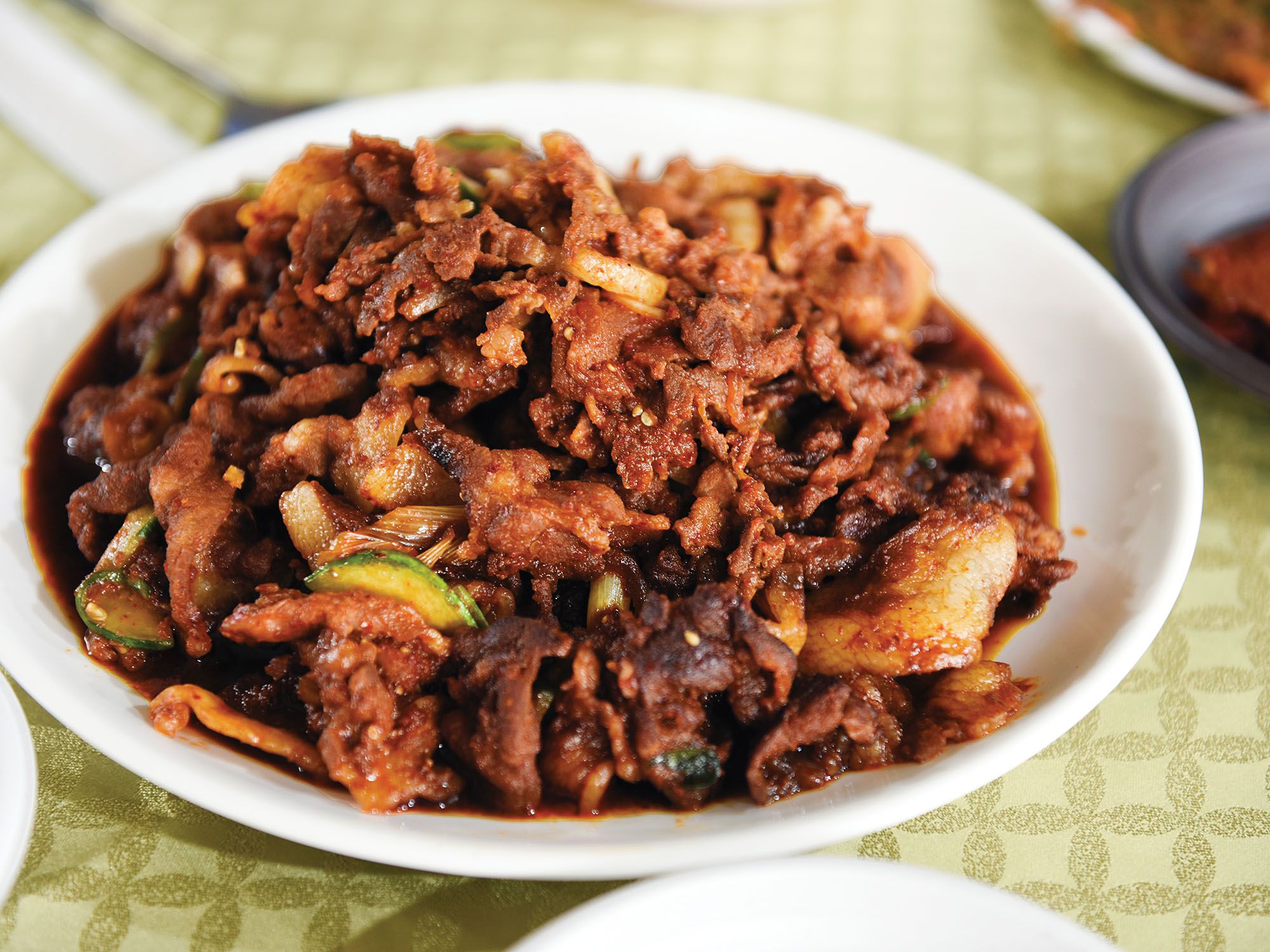 <em>Bokkeum</em> is an umbrella term given to dishes—often made with inexpensive, strong-flavored cuts of meat—that are stir-fried over high heat. Pork belly is the most popular version, but other classics include octopus, mackerel, and dried anchovies. The sweet and spicy gochujang-laced marinade helps the meat caramelize as it cooks. Get the recipe for <a href="https://www.saveur.com/korean-pork-belly-stir-fry-recipe/">Korean Spicy Stir-Fried Pork Belly (Jeyuk Bokkeum)</a>