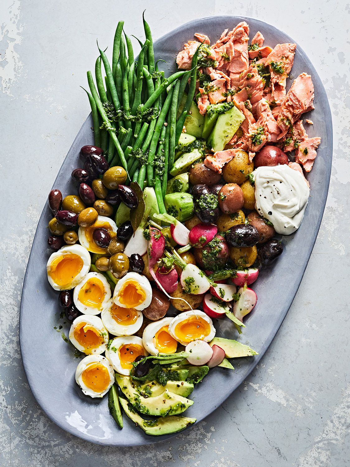 This fresh take on the classic dish from Nice, France does away with the lettuce and pairs succulent wild salmon instead of tuna with crisp vegetables, briny olives, and an umami-packed vinaigrette made with garlic, anchovies, basil, and scallions. Get the recipe for <a href="https://www.saveur.com/salmon-nicoise-salad-with-garlic-herb-dressing-recipe/">Salmon Niçoise Salad with Garlic-Herb Dressing</a>