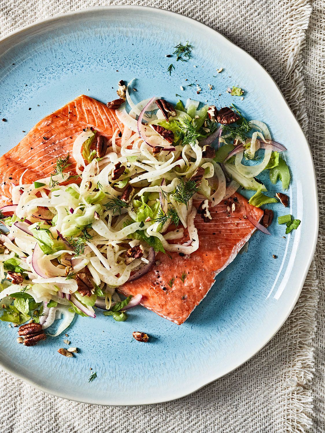 There are two secrets to this succulent salmon: start with a bigger cut of fish for easy cooking, then top with a fennel, onion, and celery salad for some much-needed brightness and crunch. Get the recipe for <a href="https://www.saveur.com/roasted-salmon-with-fennel-and-pecans-recipe/">Roasted Salmon with Fennel and Pecans</a>