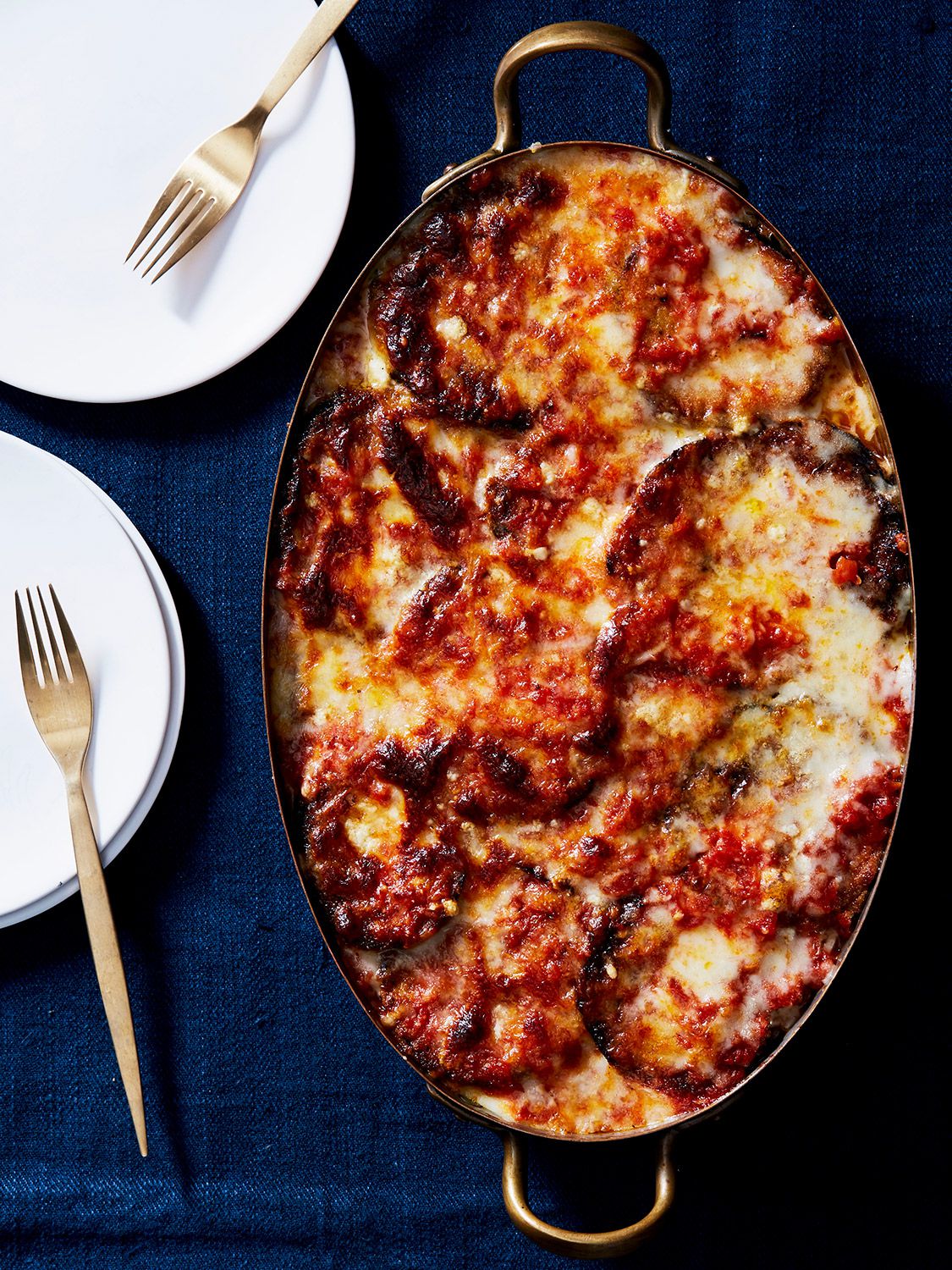 Fried eggplant is layered with homemade red sauce and two types of cheese—mozzarella and Pecorino Romano—in this family recipe from SAVEUR's former editor-in-chief Stacy Adimando. Get the recipe for <a href="https://www.saveur.com/eggplant-parmigiana-recipe/">Eggplant Parmigiana</a>