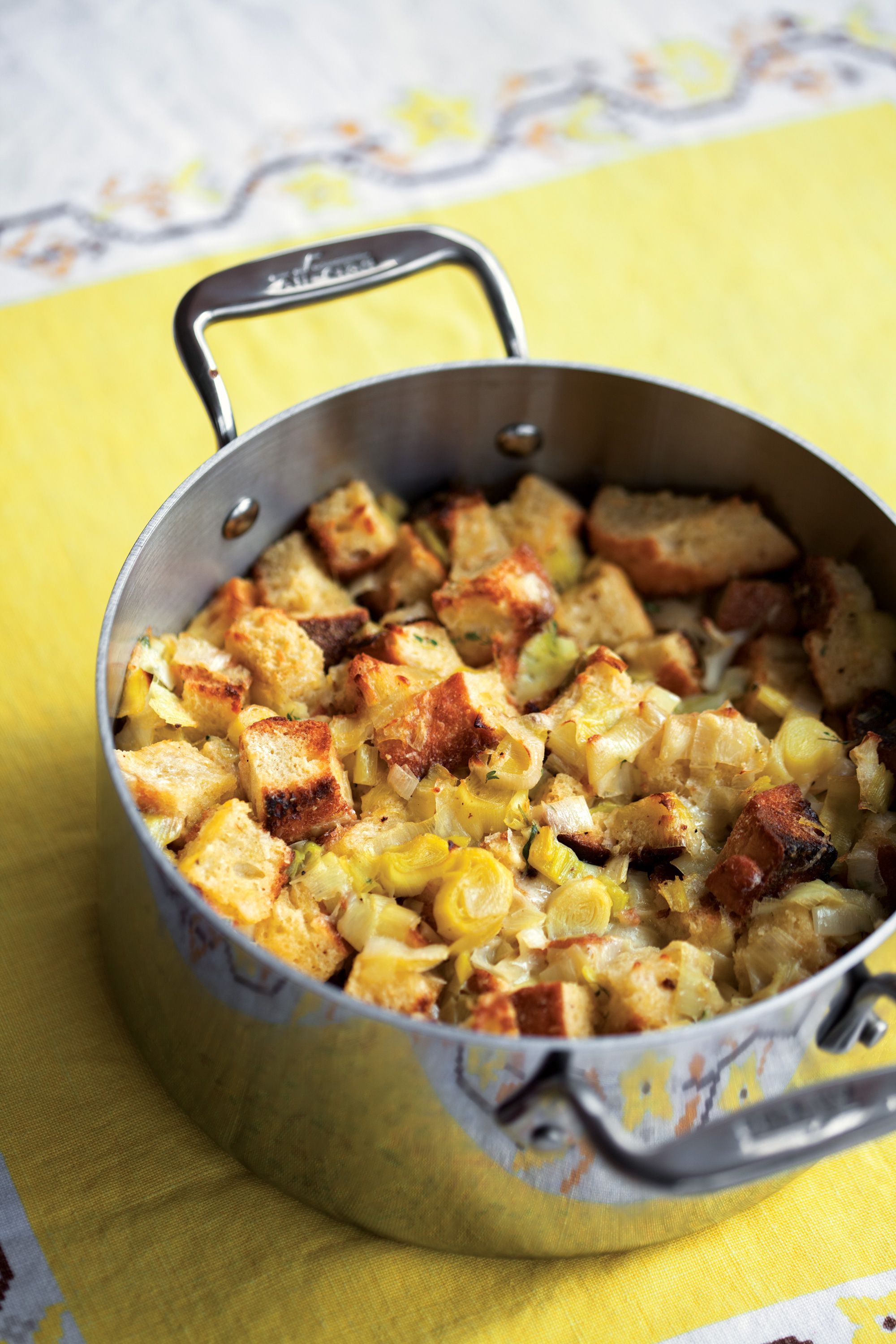 The chewy sourdough bread cubes in this savory side dish soak up custard for a creamy interior and toast to a golden brown for a crunchy topping. Get the recipe for <a href="https://www.saveur.com/article/recipes/leek-bread-pudding/">Leek Bread Pudding</a>