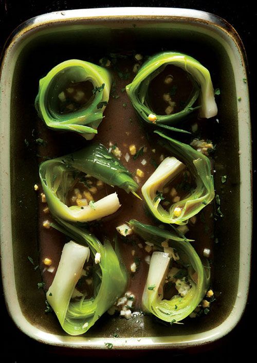 The origins of leeks vinaigrette—poached leeks in a mustardy dressing—are unknown, but it's easy to imagine someone pulling them out of the stockpot once they had worked their magic, then seasoning them. Get the recipe for <a href="https://www.saveur.com/article/Recipes/Leeks-Vinaigrette/">Poireaux Vinaigrette (Marinated Leeks with Herbs)</a>