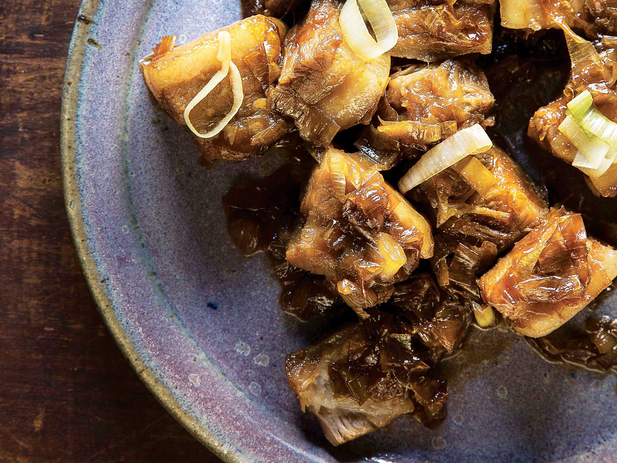 Awamori, a lightly sweet rice distillate, is used to blanch and cook—as well as coat—tender pork belly, resulting in a sticky, umami-rich sauce. Get the recipe for <a href="http://www.saveur.com/braised-pork-belly-with-leeks-and-ginger-recipe">Braised Pork Belly with Leeks and Ginger</a>