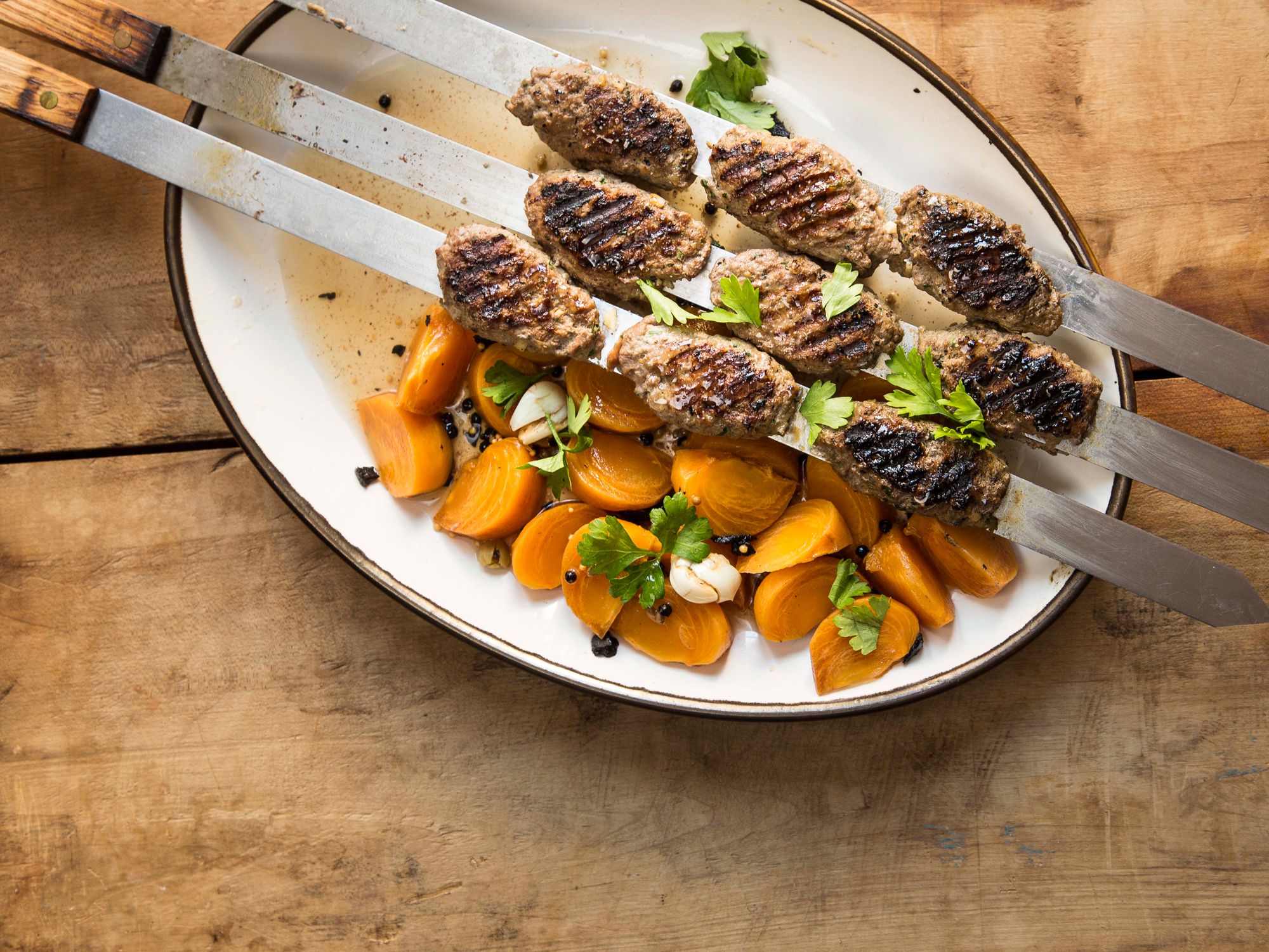 Minimally-spiced Romanian beef kebabs are grilled until lightly charred and served with intense, bright pickled persimmons in this take on Israeli street food. Get the recipe for <a href="http://www.saveur.com/grilled-ground-beef-kufta-kebabs-pickled-persimmons-recipe">Grilled Beef Kebabs with Pickles Persimmons</a>