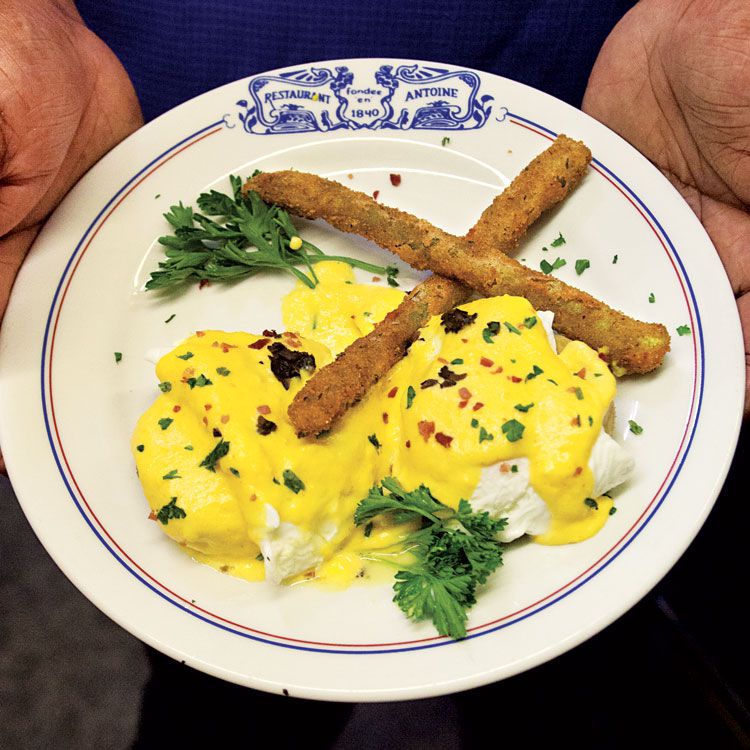 Eggs Sardou is an ornate New Orleans classic, with anchovies tucked in between egg and artichoke, and a thick hollandaise sauce blanketing the entire dish, scattered with handfuls of minced black truffle, parsley, and ham and served with elegant fried asparagus spears. Get the recipe for <a href="https://www.saveur.com/article/Recipes/Classic-Eggs-Sardou/">Eggs Sardou</a>