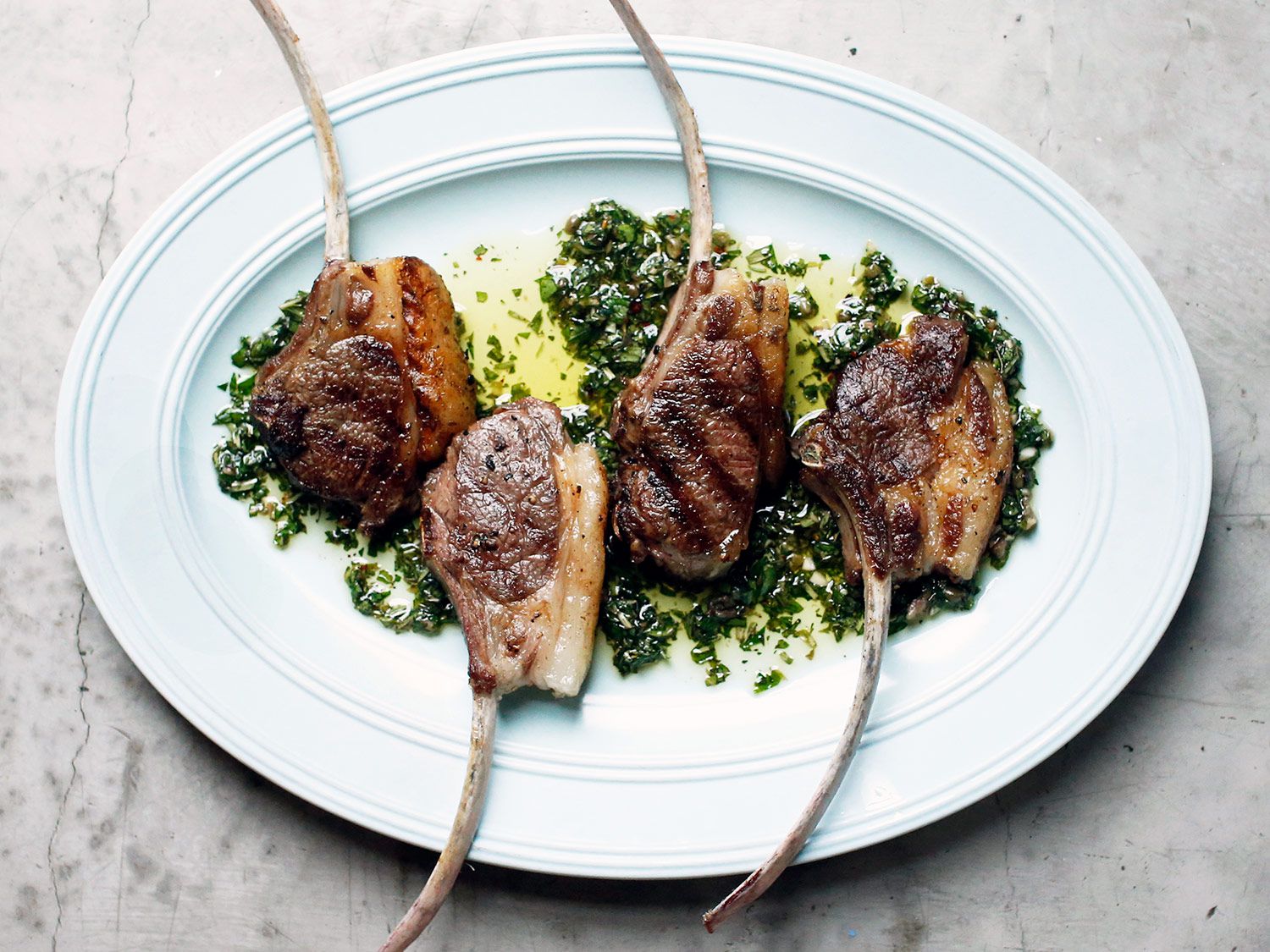 Salsa verde, a Mediterranean condiment flavored with anchovies, capers, and herbs, partners nicely with seared, medium-rare lamb chops. A high-acid, ultra-crisp white, such as a txakolina from Spain's Basque Country, matches the briny notes of the sauce. Get the recipe for <a href="https://www.saveur.com/article/Recipes/Lamb-Chops-with-Mint-Salsa-Verde/">Grilled Lamb Chops with Mint Salsa Verde</a>