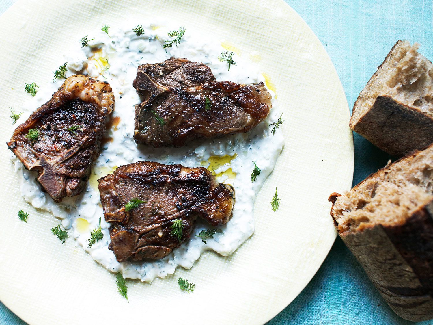 In this classic Greek pairing, dill is used two ways: first in a garlicky marinade for the lamb, and then in a cooling, brightly flavored yogurt sauce. Serve this dish with a simple green salad. Get the recipe for <a href="https://www.saveur.com/article/Recipes/Grilled-Lamb-Chops-with-Tzatziki-Sauce/">Grilled Lamb Chops with Tzatziki Sauce</a>