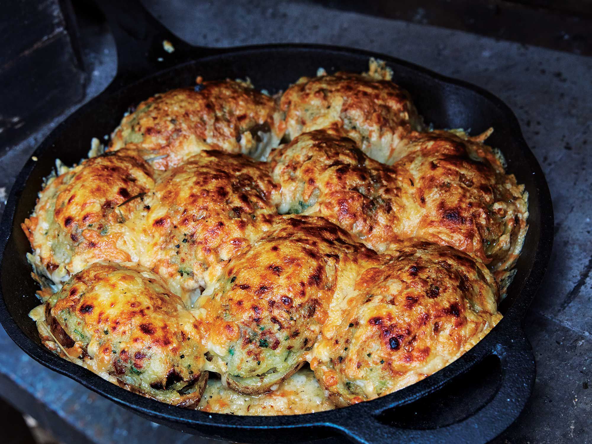 These stuffed potatoes, which tenderize first in foil packets then crisp up in cast iron atop the coals (or in the oven), are packed with a mix of roasted chestnuts, bacon, and juicy whole clams. Get the recipe for <a href="https://www.saveur.com/potatoes-with-chestnuts-and-clams-recipe/">Potatoes with Chestnuts and Clams</a>