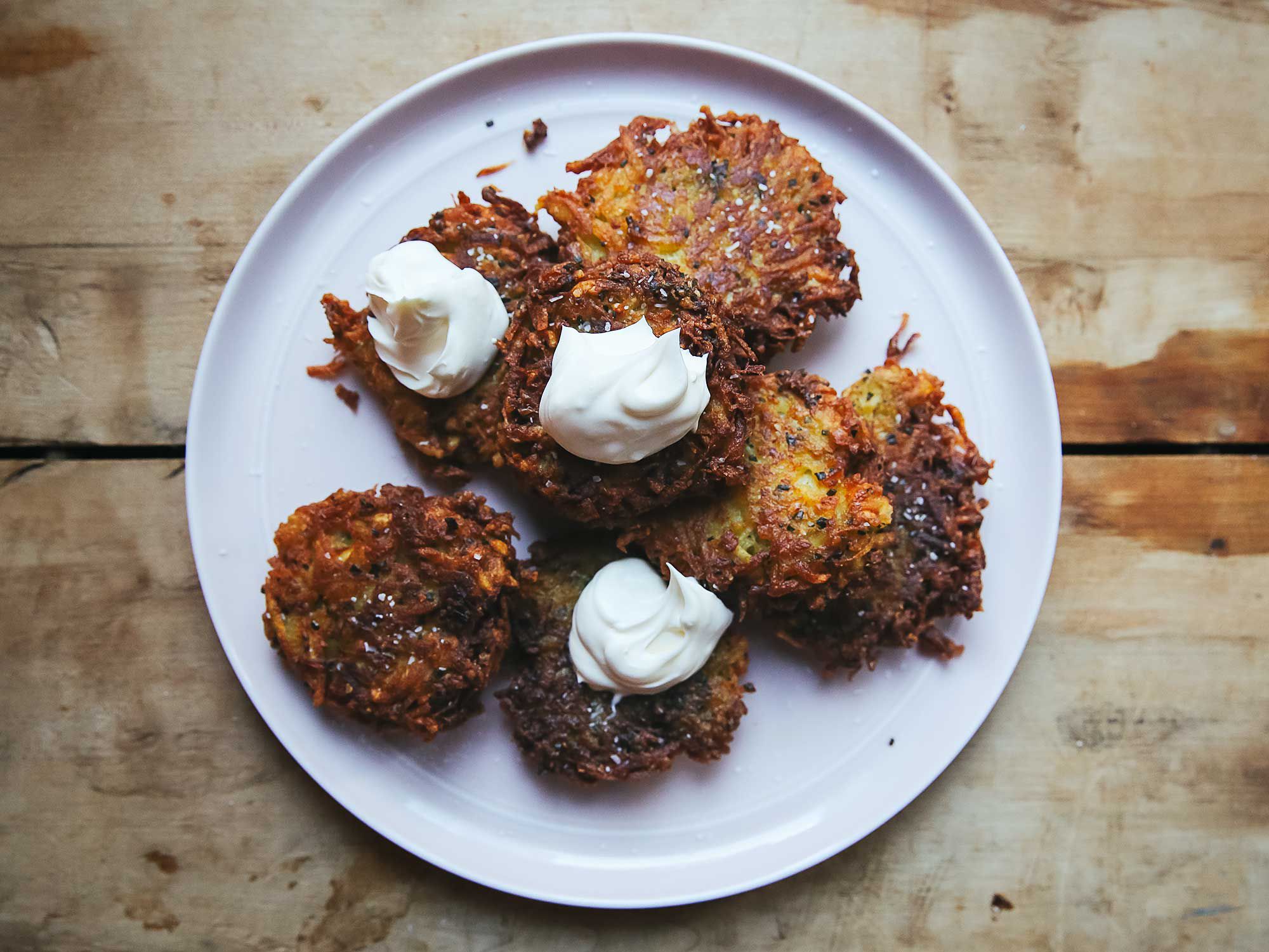 Learn how to make our classic latkes. Author Joan Nathan, from whom this recipe is adapted, likes hers with applesauce; we find them equally delectable with sour cream. Alternating between onion and potatoes when grating keeps the potatoes from darkening. Get the recipe for <a href="https://www.saveur.com/classic-latkes-recipe/">Classic Latkes</a>