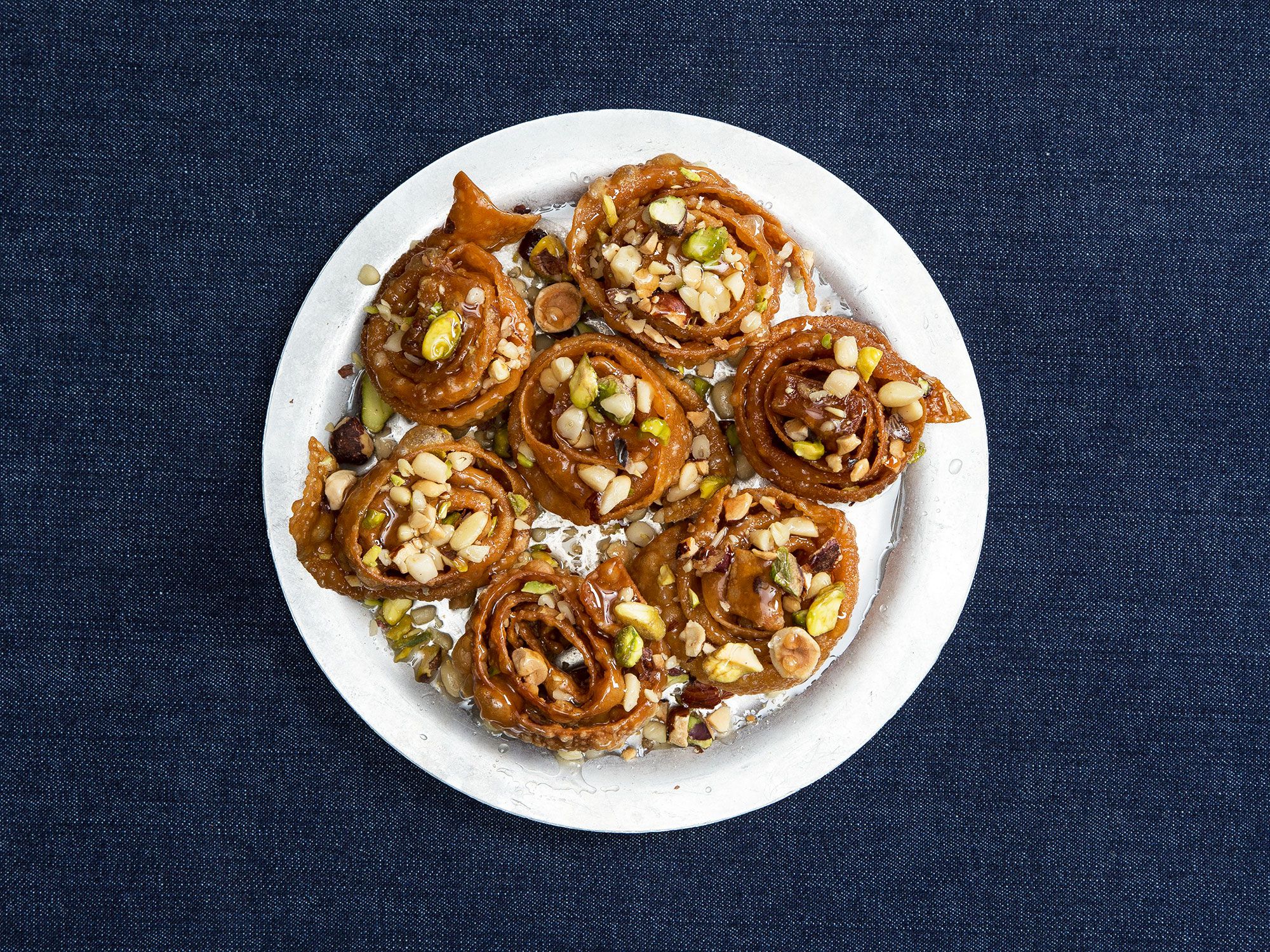 These crunchy pastry spirals are formed from a simple pasta-like dough, soaked in a light lemon syrup and sprinkled with a shower of mixed nuts. Get the recipe for <a href="http://www.saveur.com/syrup-soaked-pastries-with-hazelnuts-pistachios-and-pine-nuts-deblah-recipe">Syrup-Soaked Pastries with Hazelnuts, Pistachios, and Pine Nuts (Deblah)</a>