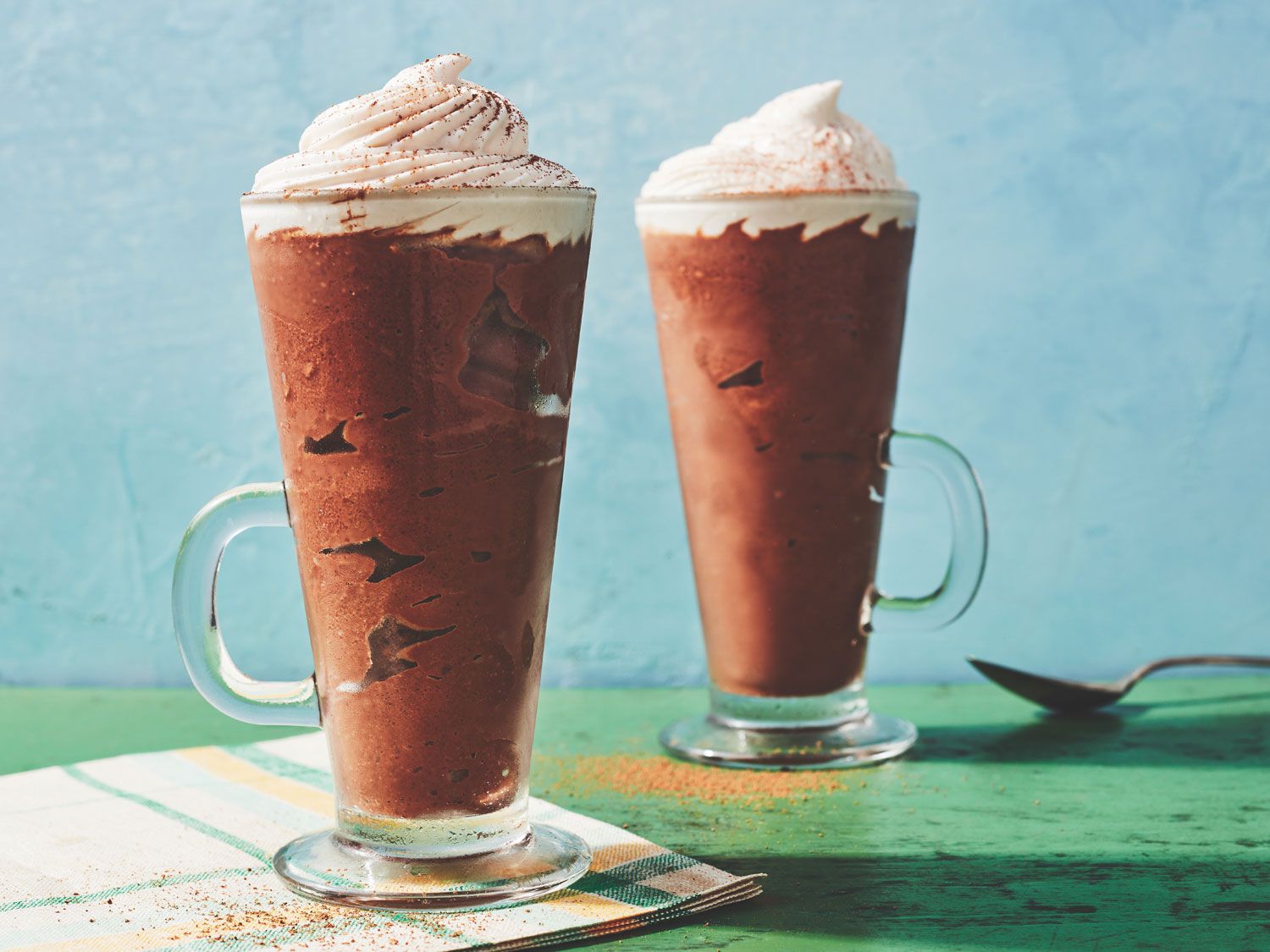 A chocolately winter favorite gets the hot weather treatment in this icy frozen drink from San Francisco's Dandelion Chocolate. Get the recipe for <a href="https://www.saveur.com/story/recipes/frozen-hot-chocolate-with-cacao-nib-cream/">Frozen Hot Chocolate with Cacao Nib Cream</a>