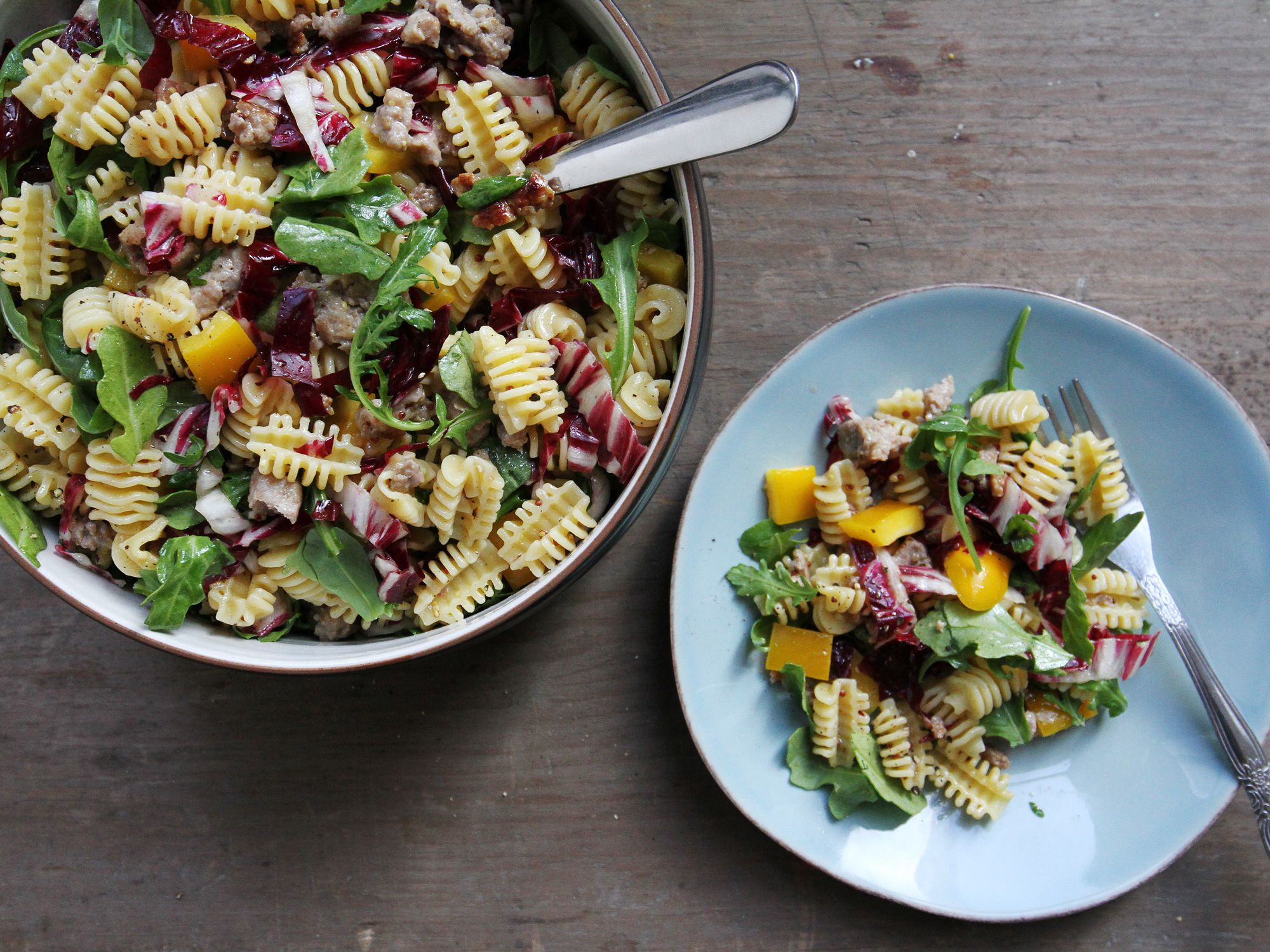 Pasta salads are essential summer food: they travel well; they're easy to adapt to whatever produce you have on-hand; and they're simple to make in large portions, making them perfect dishes to carry to parties, picnics, and barbecues. Get the recipe for <a href="https://www.saveur.com/sausage-and-arugula-pasta-salad-recipe/">Sausage and Arugula Pasta Salad</a>