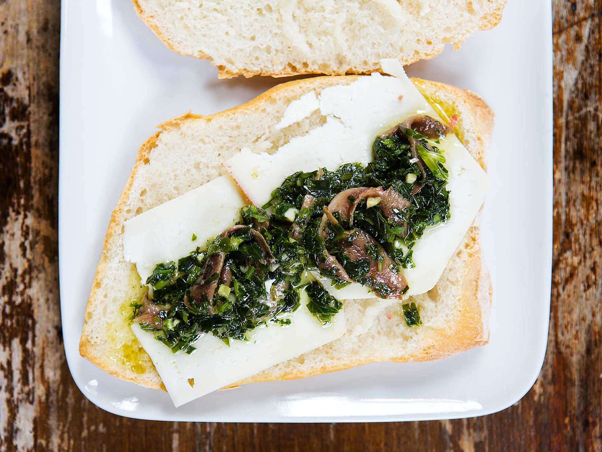 This crusty sandwich only calls for a handful of ingredients—pecorino, parsley, and anchovy—but has big flavors. Get the recipe for <a href="http://www.saveur.com/pecorino-parsley-anchovy-sandwiches-recipe">Pecorino, Parsley, and Anchovy Sandwiches</a>