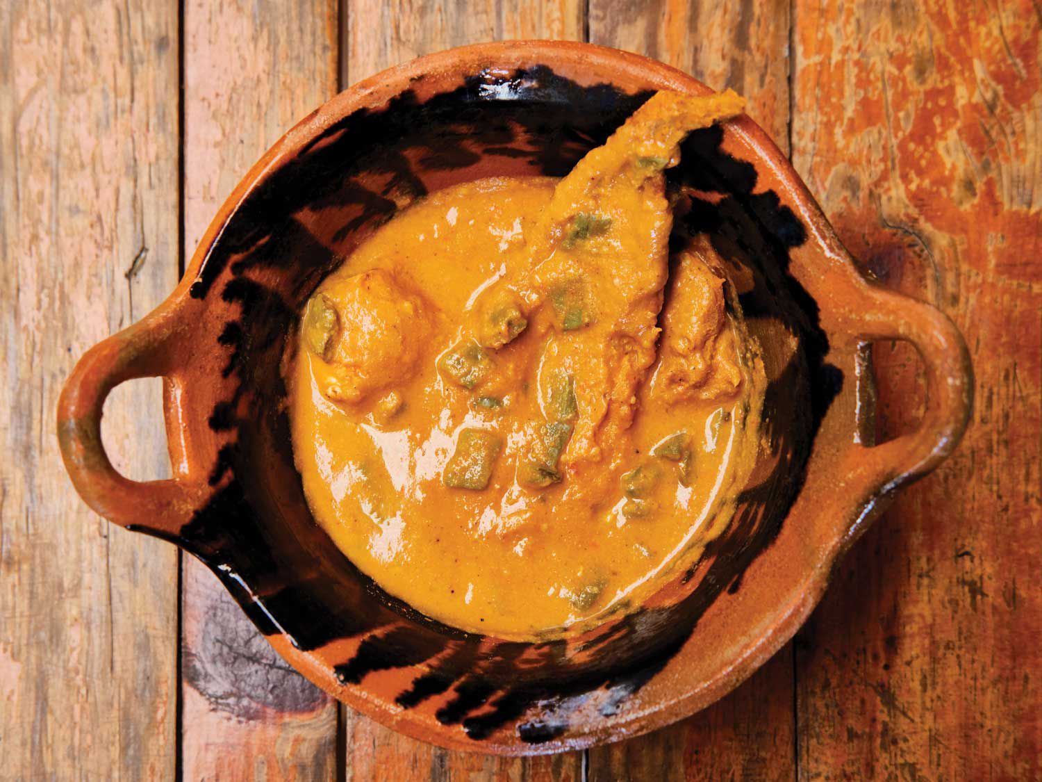 Dried fish and cactus paddles lend flavor and depth to this light and tangy mole; serve it with fresh tortillas for sopping up the sauce. Get the recipe for <a href="https://www.saveur.com/story/recipes/yellow-mole-with-fish-and-cactus-paddles/">Yellow Mole with Fish and Cactus Paddles (Mich Mole)</a>