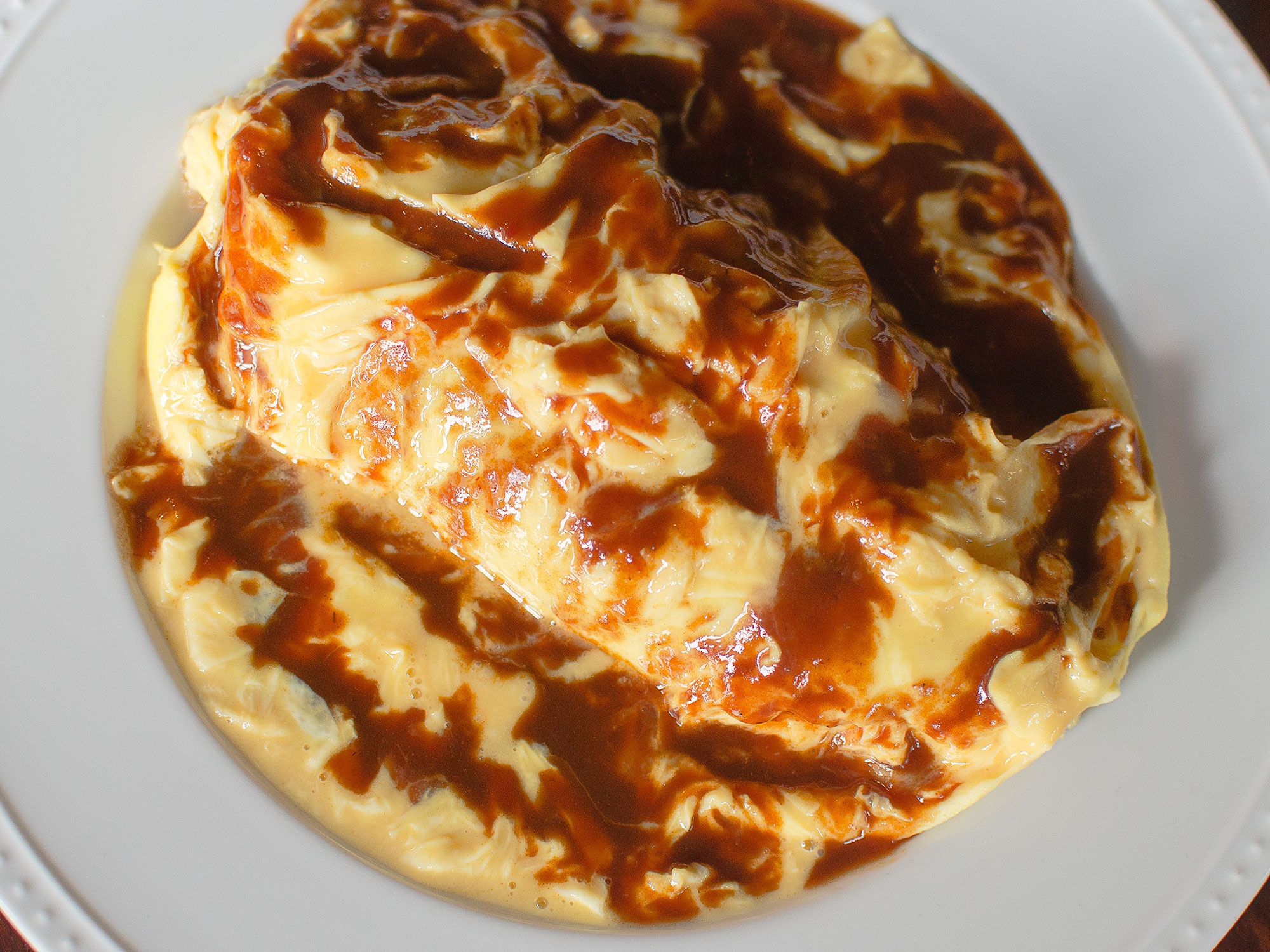 A Japanese home-cooking classic: tender soft-scrambled eggs over savory fried rice. Get the recipe for <a href="https://www.saveur.com/omurice-recipe/">Japanese Omelet Fried Rice (Omurice)</a>
