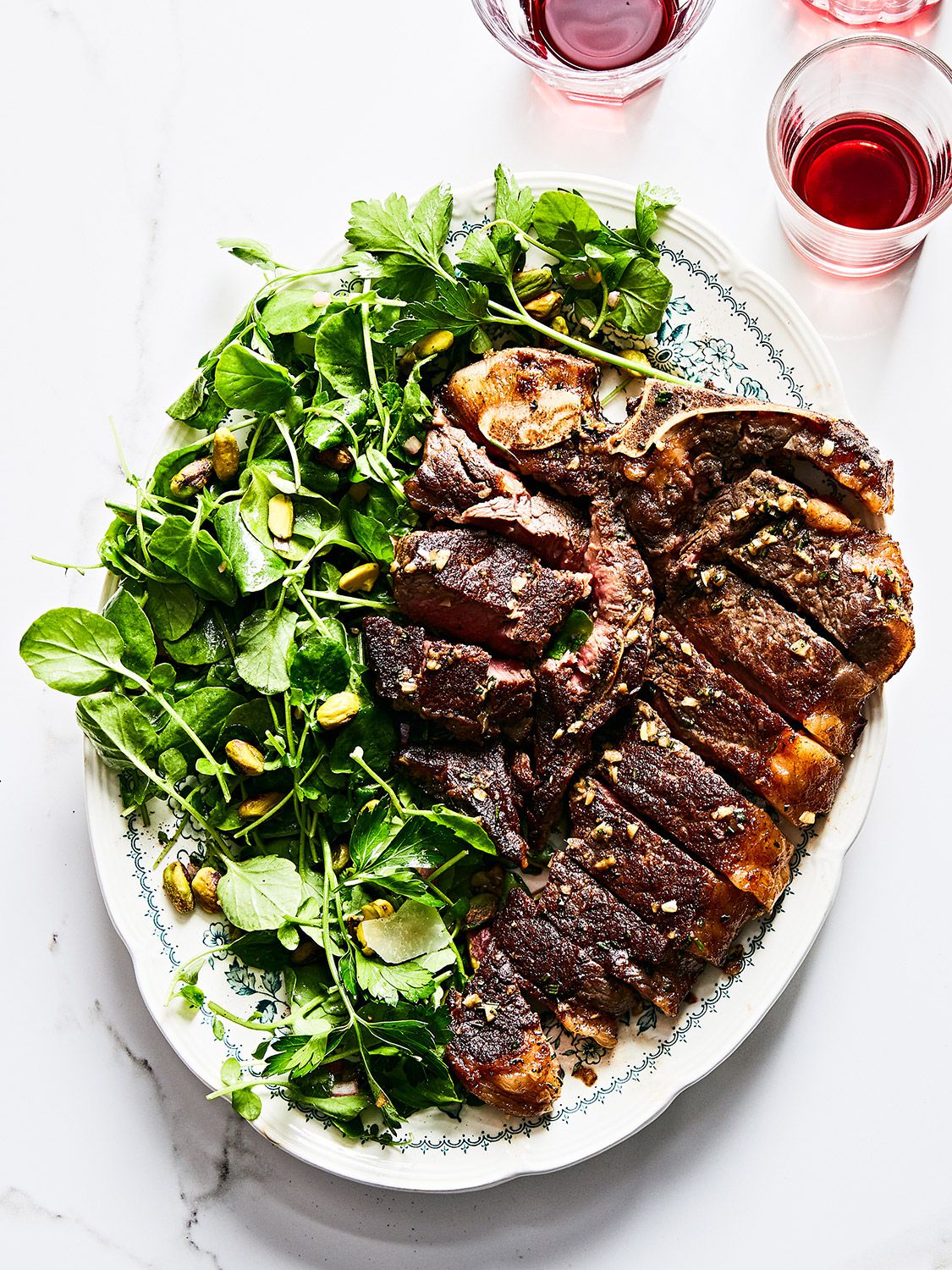 In this weeknight version of the Tuscan classic, a porterhouse steak just big enough for two is seasoned with rosemary, garlic, and anchovies, then cooked on the stovetop and served with peppery watercress and buttery pistachios. Get the recipe for <a href="https://www.saveur.com/bistecca-alla-fiorentina-with-watercress-and-pistachio-salad-recipe/">Bistecca alla Fiorentina with Watercress and Pistachio Salad</a>