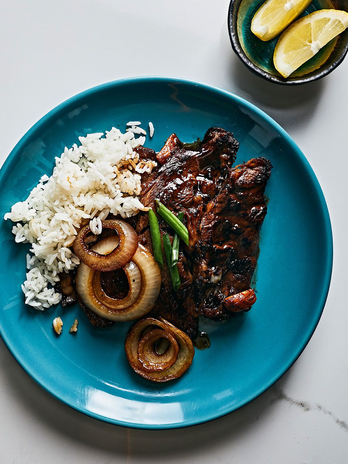 A zingy Filipino-inspired marinade turns rib-eye steak into a refreshing weeknight dinner. Pounding the meat first makes it quick to get on the table, too. Get the recipe for <a href="https://www.saveur.com/quick-filipino-style-rib-eye-steaks-bistek-tagalog-recipe/">Quick Filipino-Style Rib-Eye Steaks (Bistek Tagalog)</a>