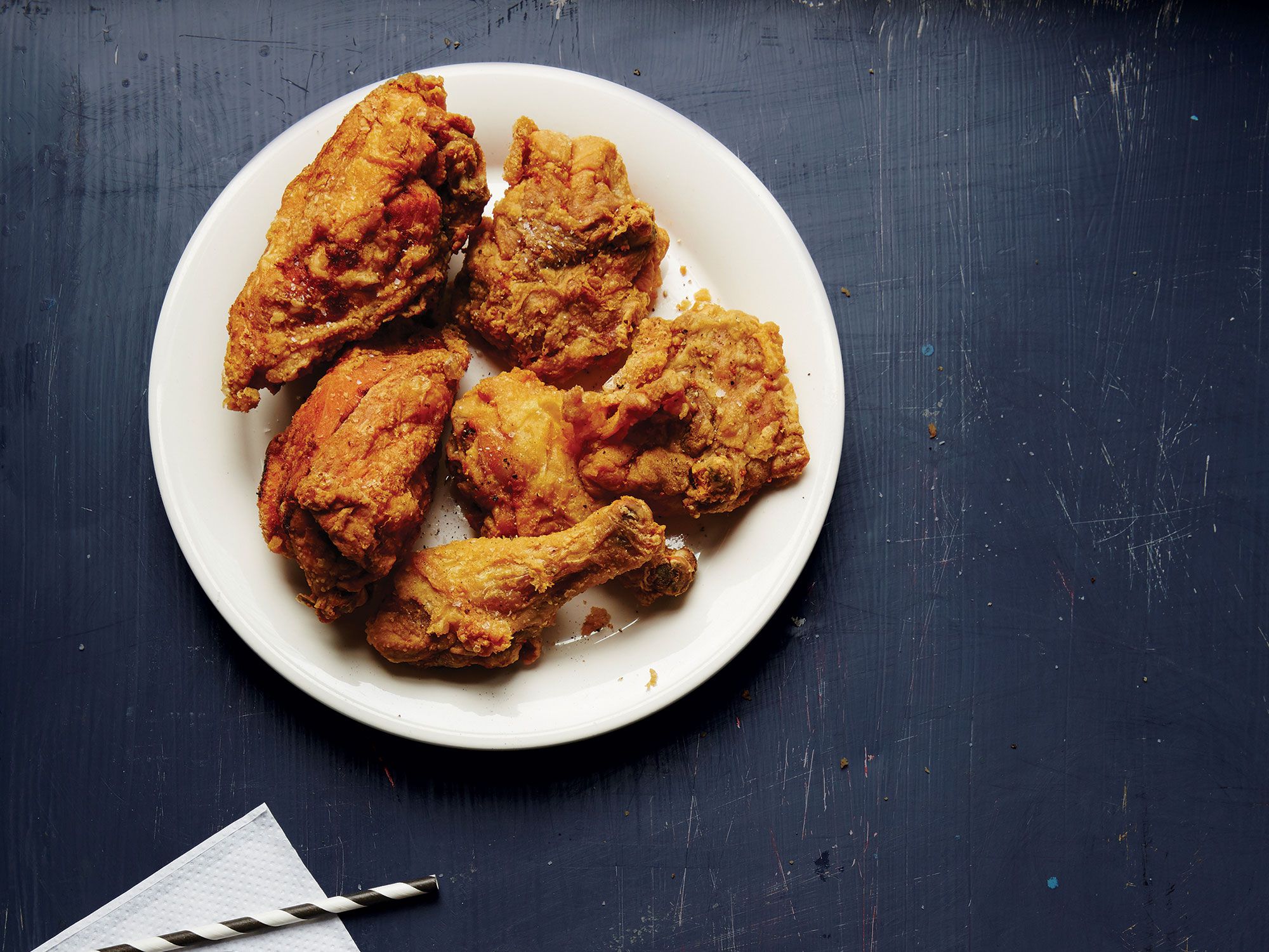 Parker's BBQ in Wilson, North Carolina, famous for its Family Platter with shatteringly crisp fried chicken, goes through seven to eight thousand chickens a week. A favorite of chef Elizabeth Karmel's, this super-simple recipe lets the flavor of the chicken shine. Get the recipe for <a href="https://www.saveur.com/article/recipes/parkers-bbq-fried-chicken/">Parker's BBQ Fried Chicken</a>